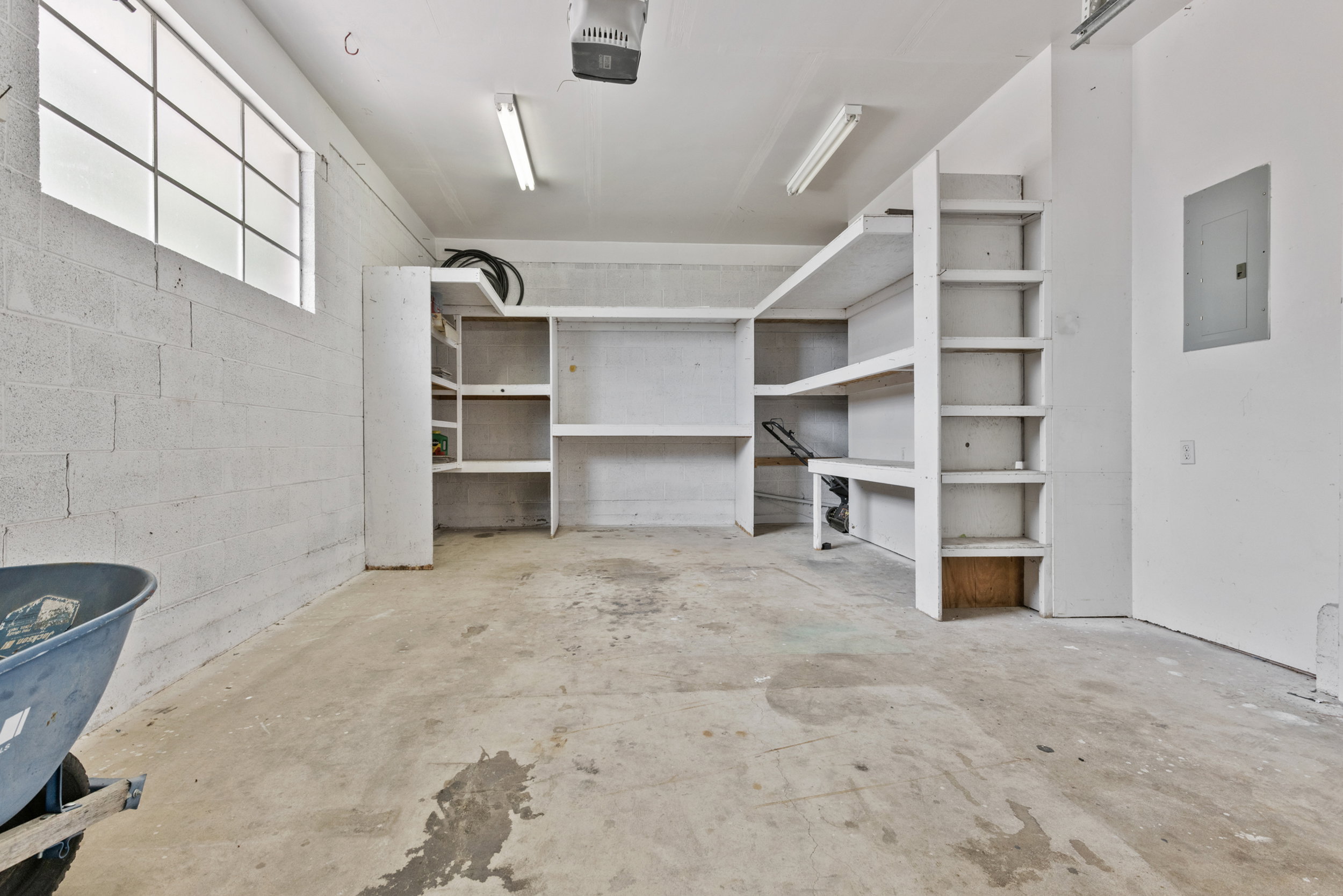 Garage interior featuring concrete flooring and painted cinder block walls