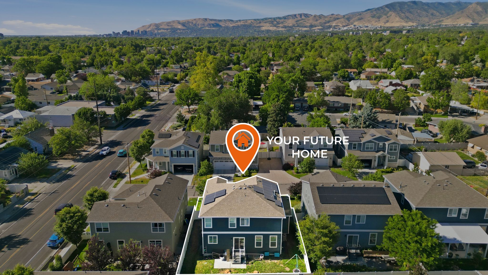 Aerial perspective showcasing a residential property with a fenced backyard and solar panels