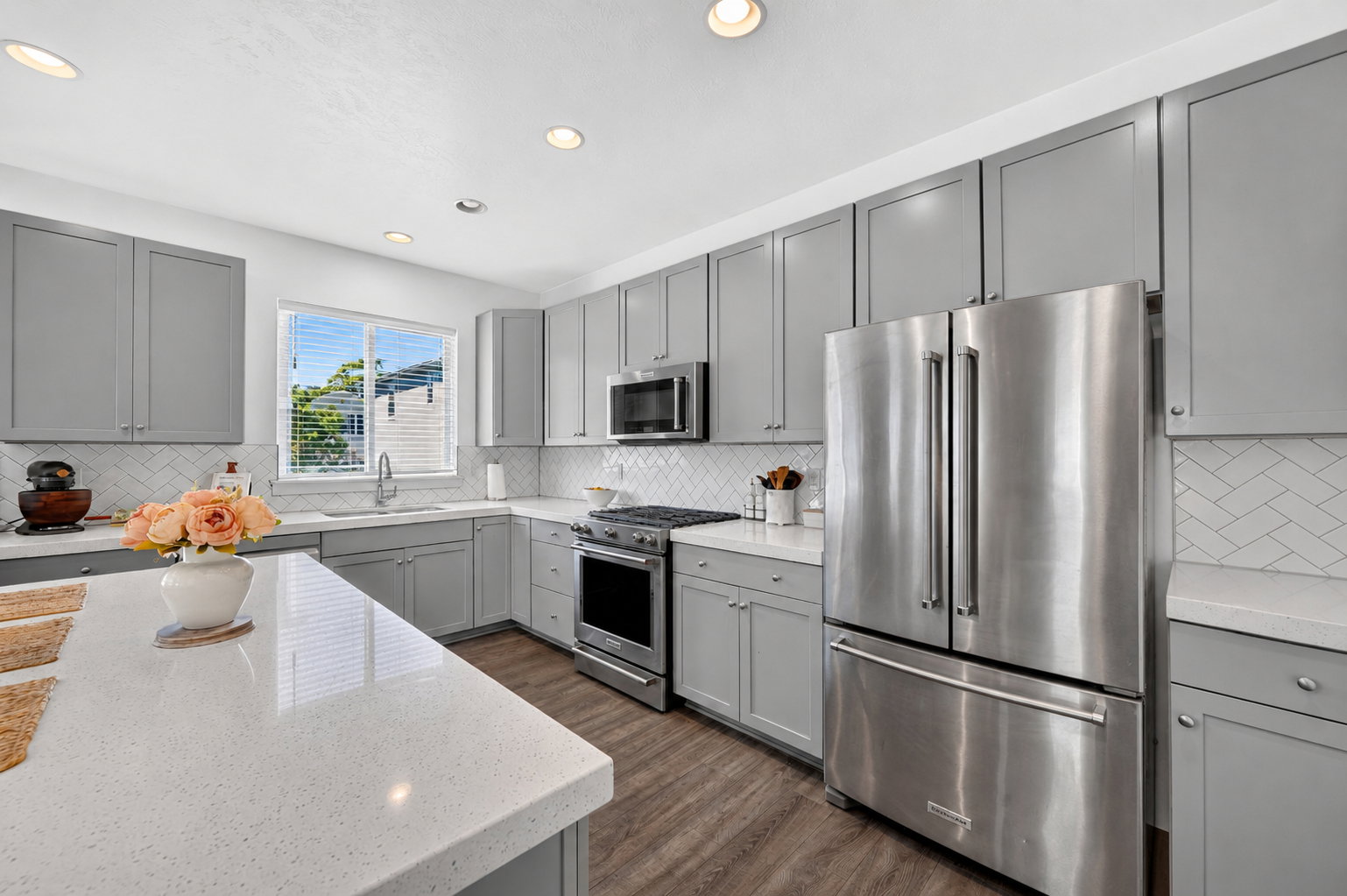 Kitchen featuring wood-finish flooring, recessed lighting, and a window with blinds