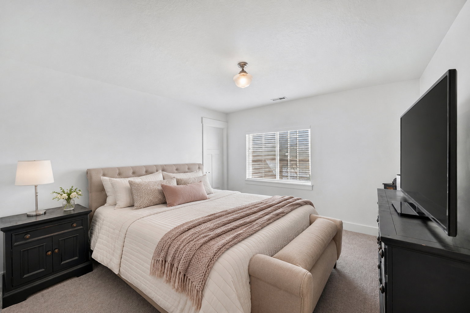 Neutral white walls with a window featuring horizontal blinds