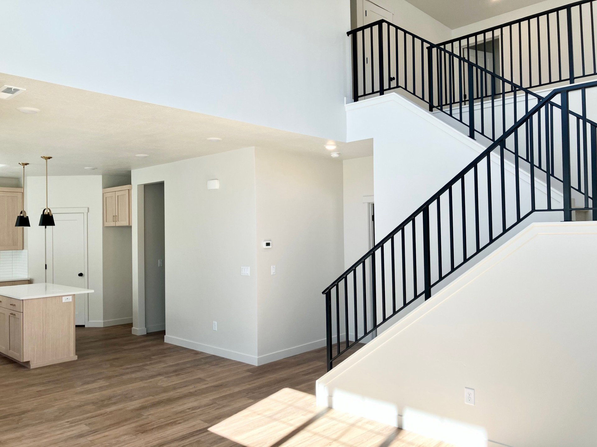 Dramatic two-story entry with contemporary black metal railings