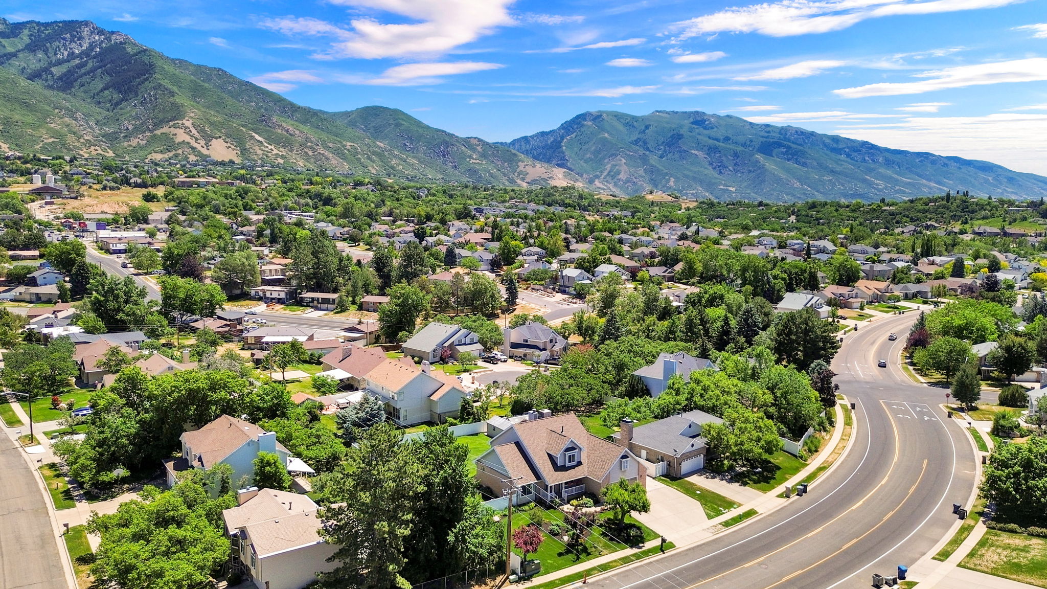 Residential community with tree-lined streets and mountain backdrop