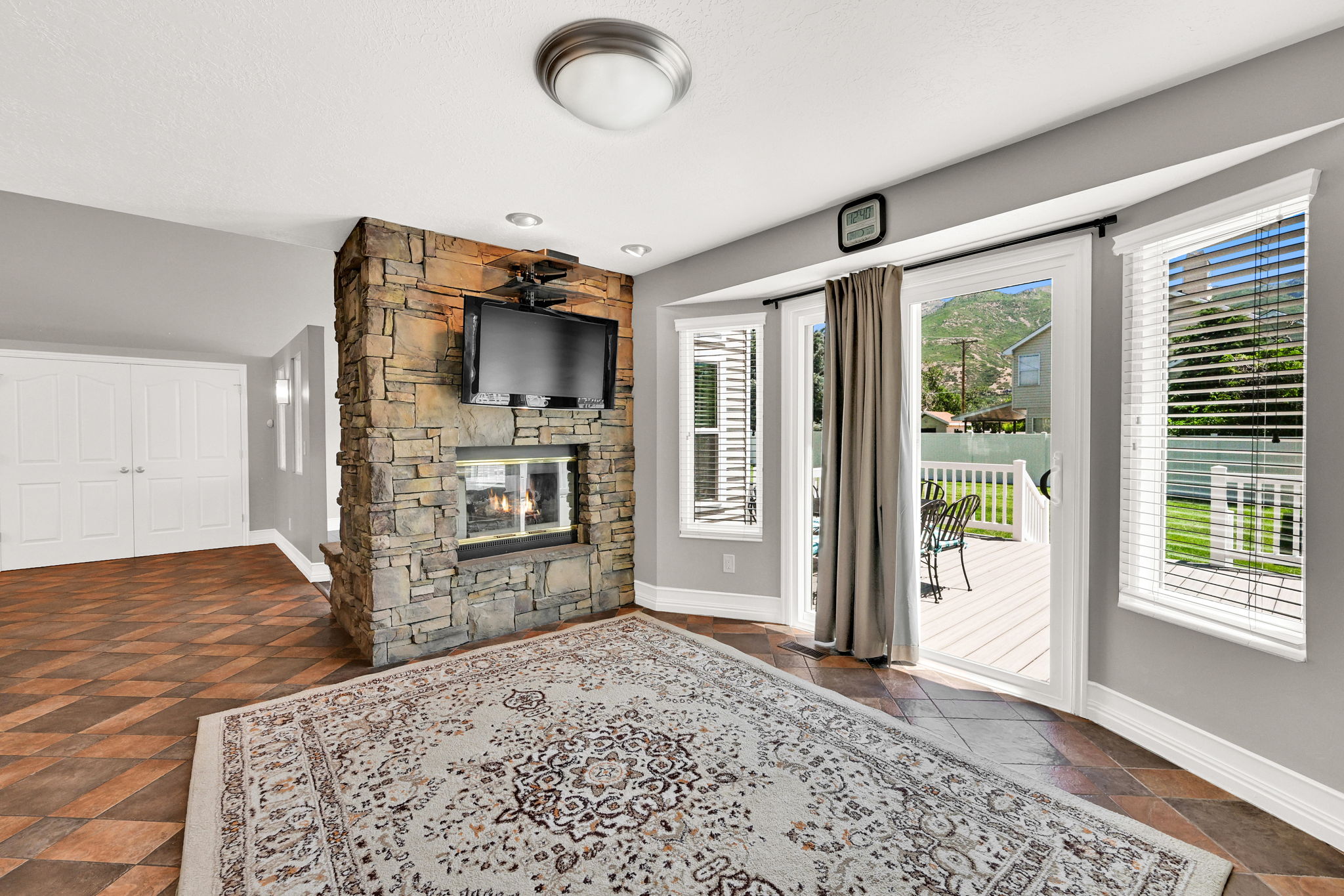 Stone-clad fireplace with a built-in media niche including TV