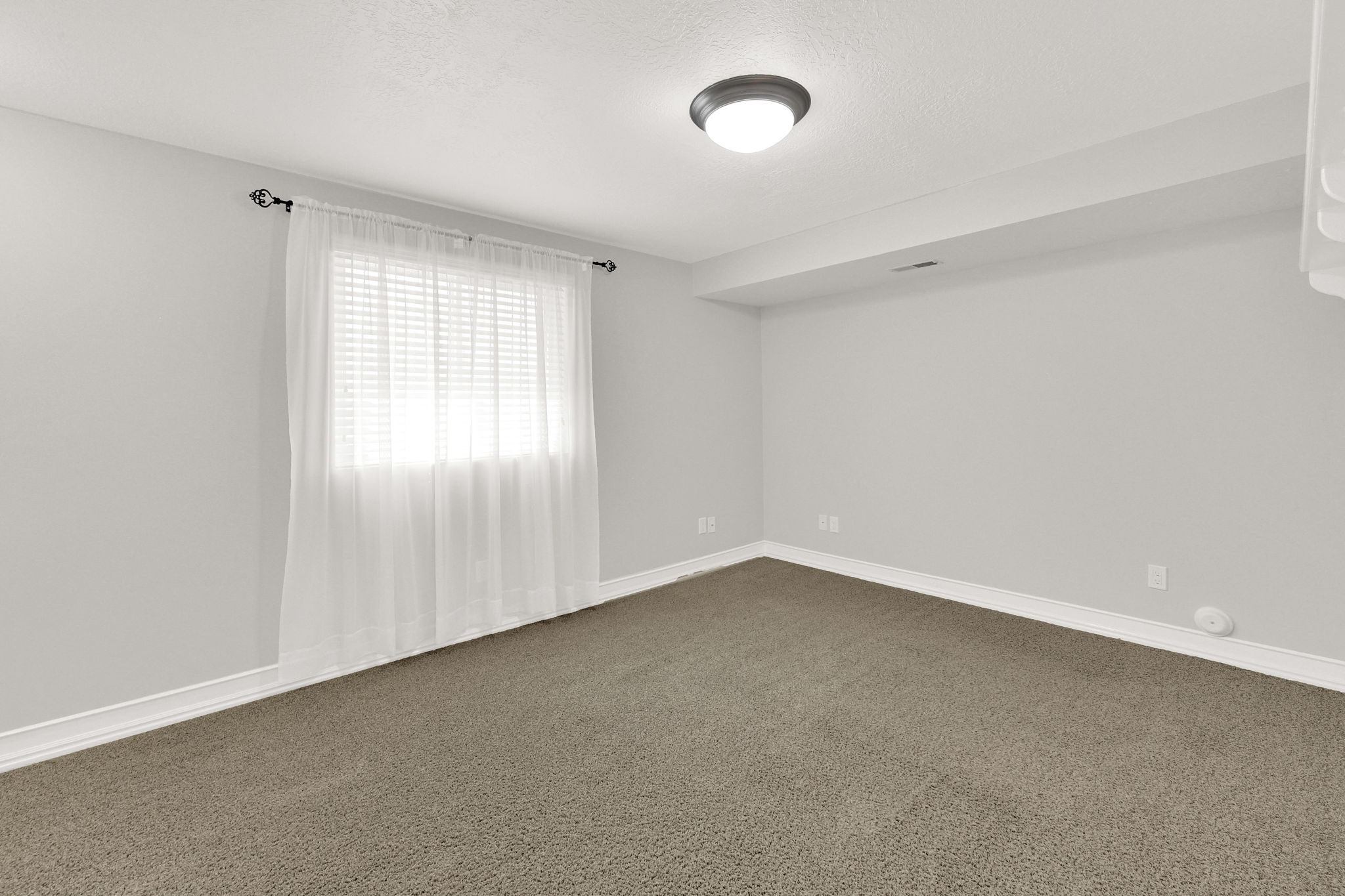 Bedroom #6 featuring light gray walls, gray carpet, and white trim