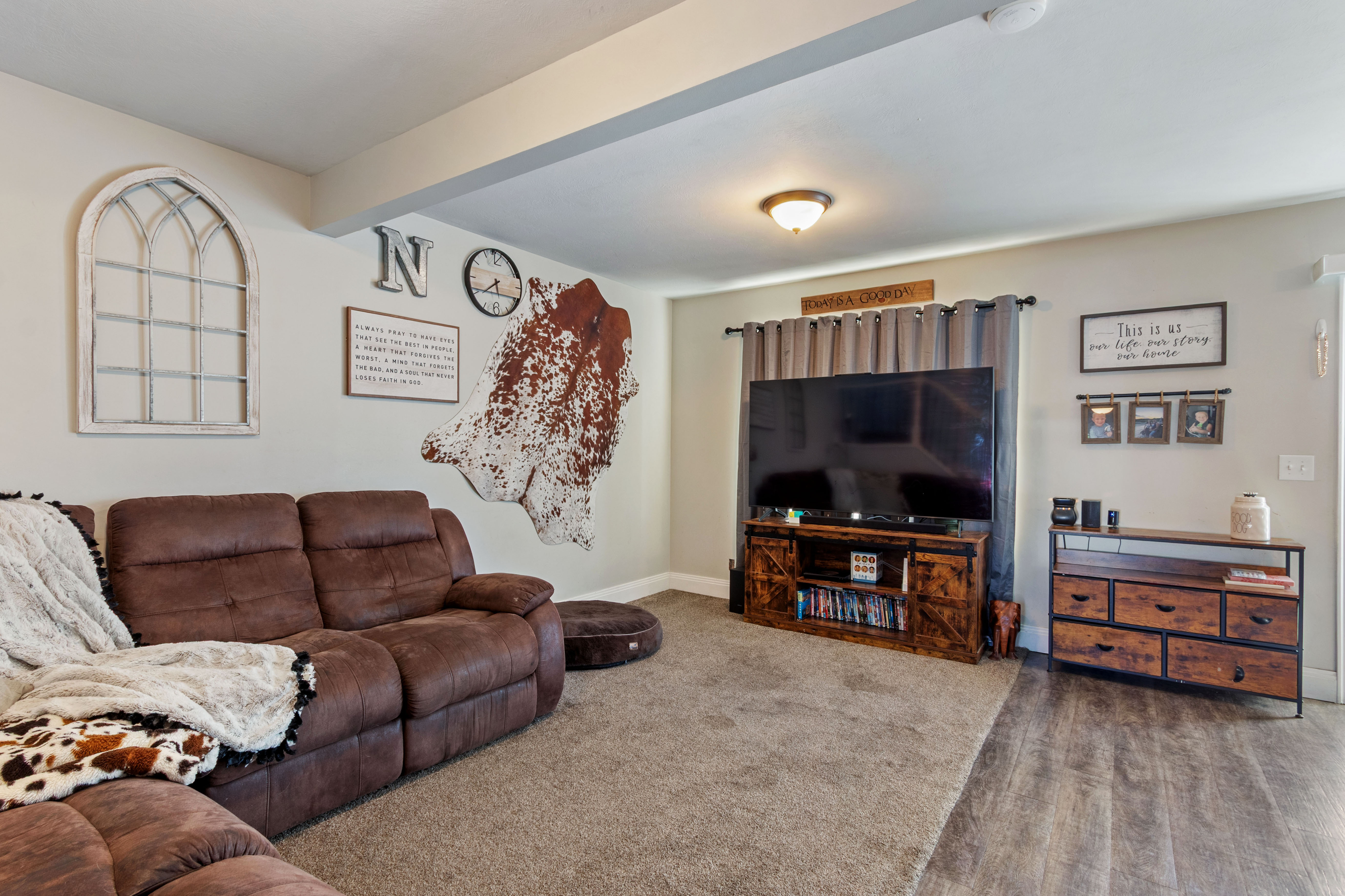 Spacious interior featuring a combination of soft carpet and wood-finish flooring