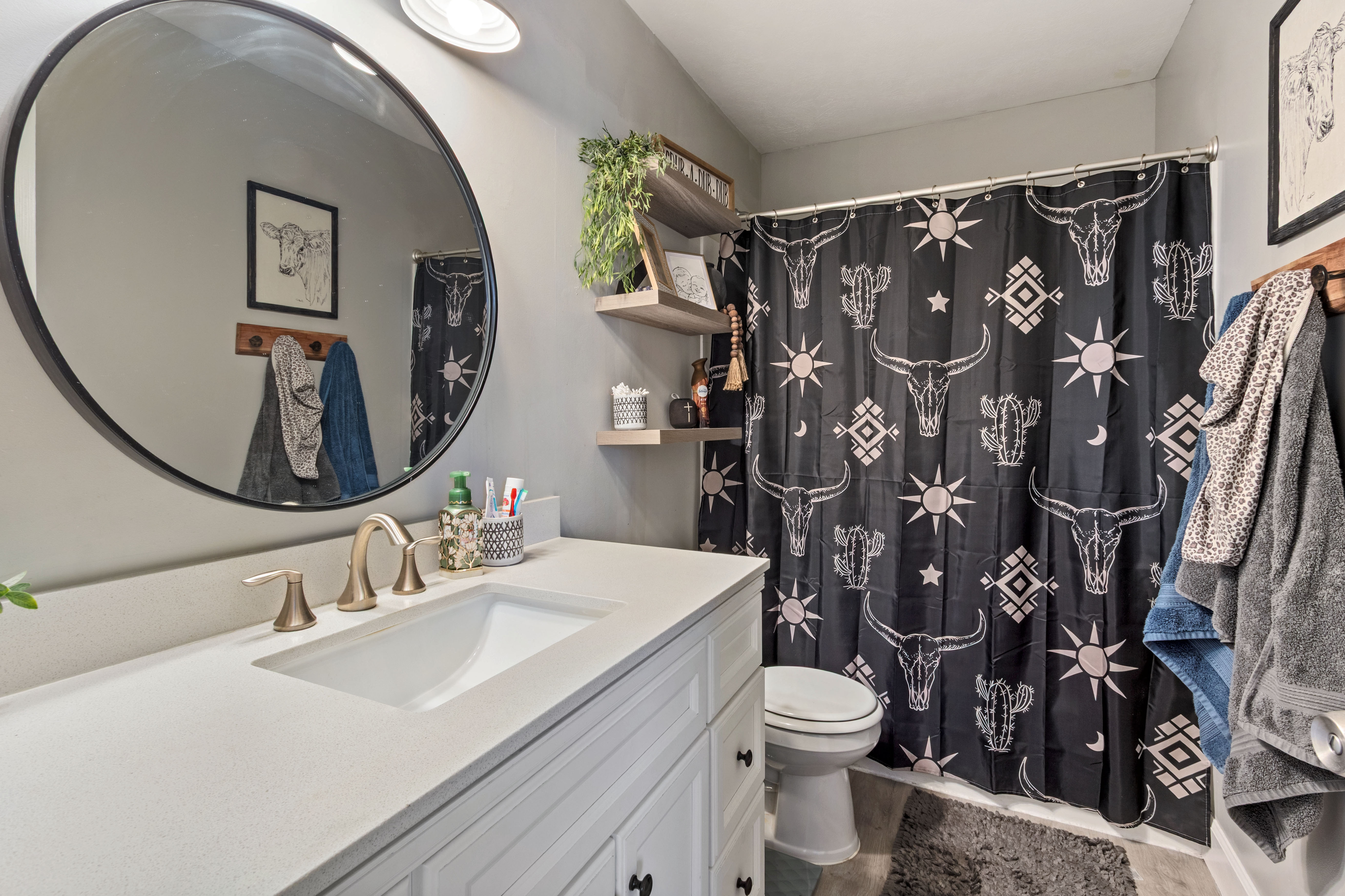 Bathroom vanity featuring a light-colored countertop with an integrated sink and brushed nickel faucet