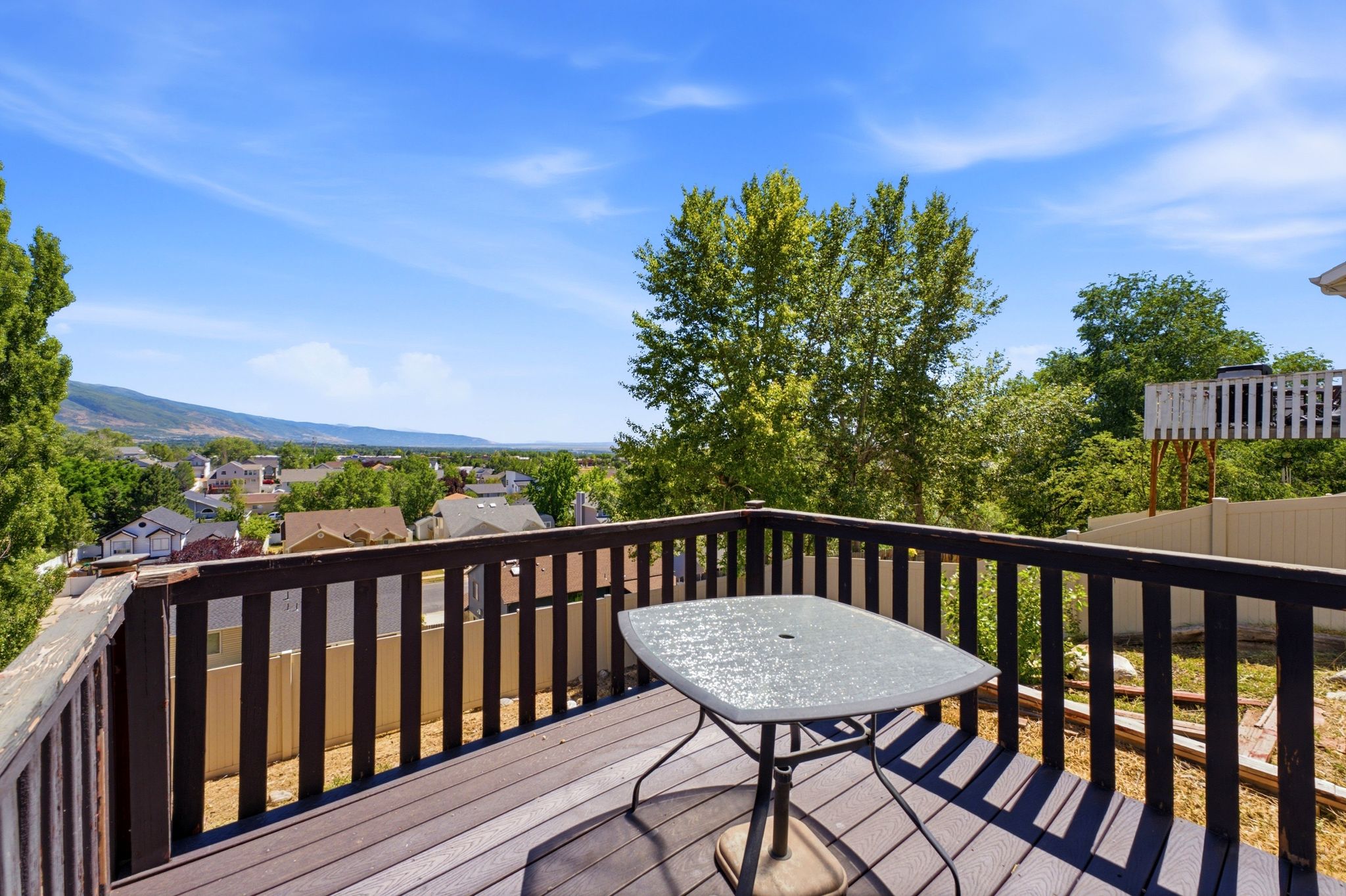 Outdoor deck featuring wood-finish decking and dark wood railings