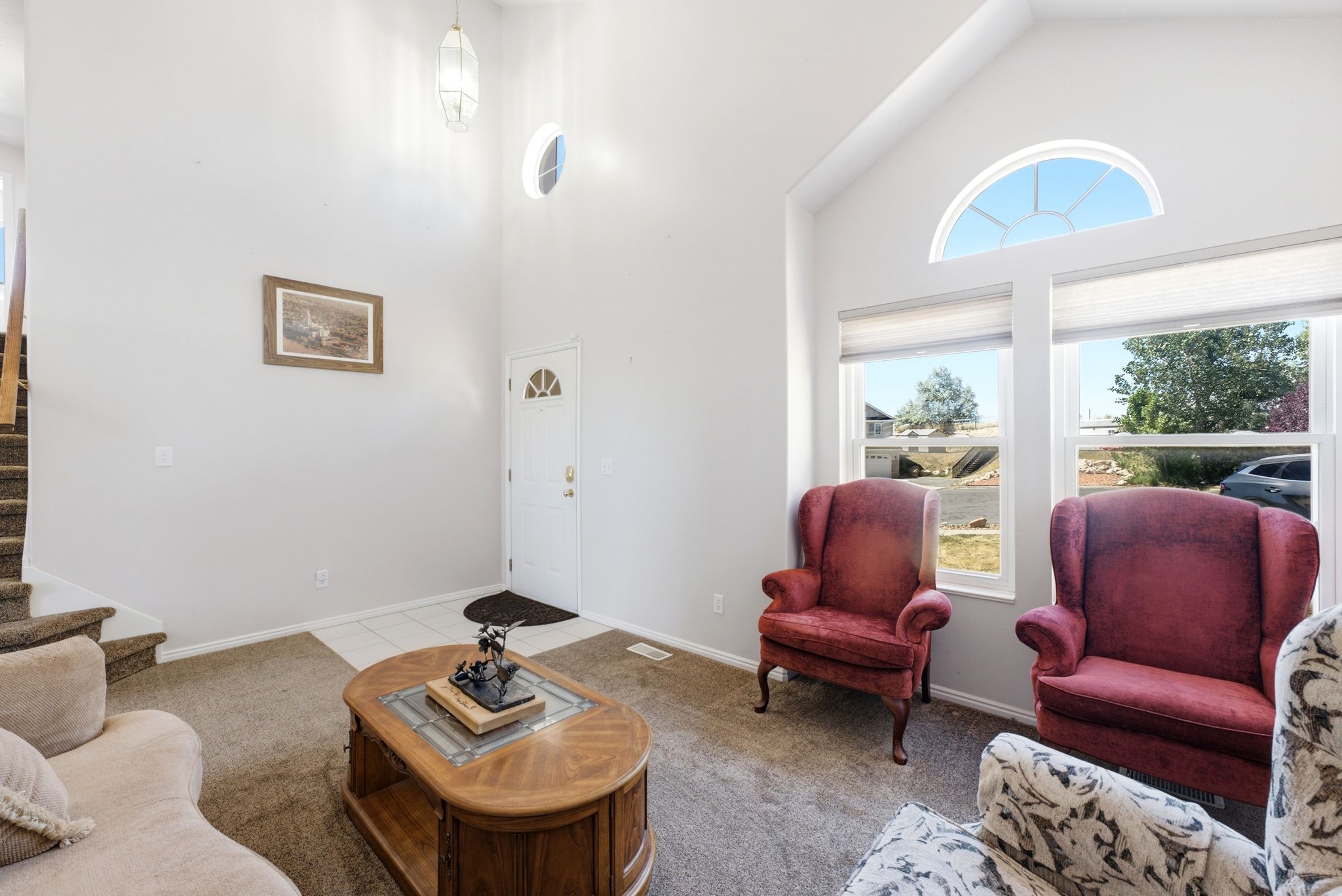 Vaulted ceilings complement the arched transom window and dual pane windows