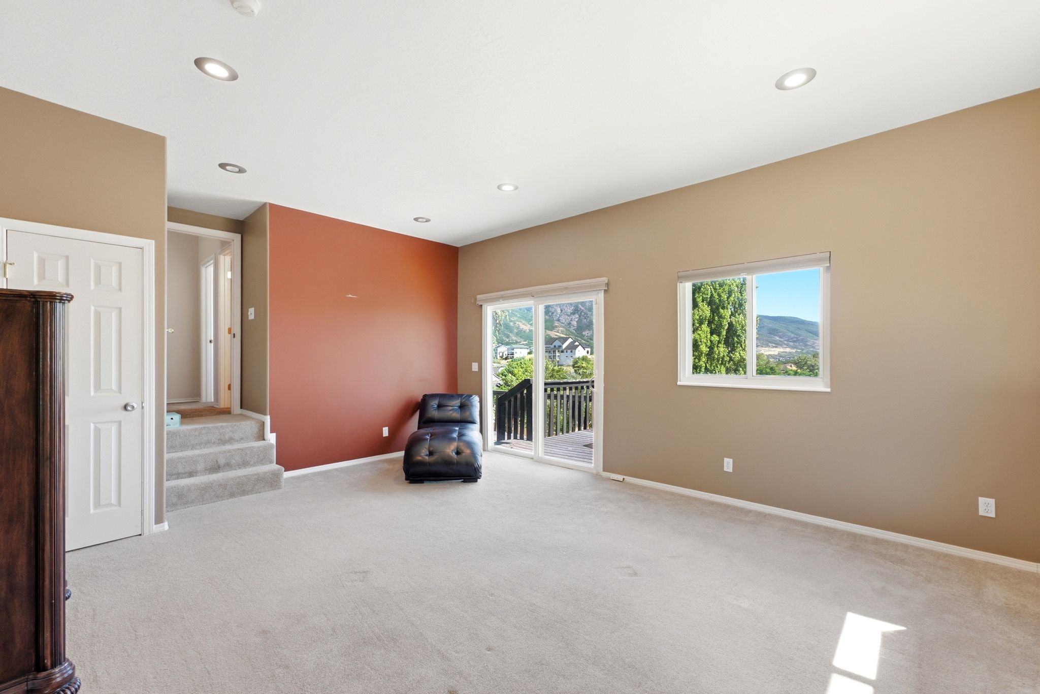 Spacious room featuring neutral carpeting and recessed lighting