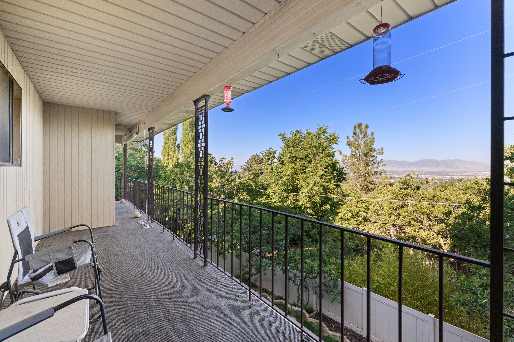 Covered deck runs N-S the length of the home on both levels