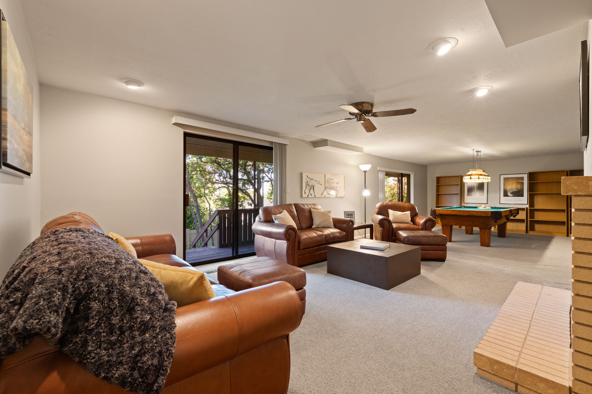 Lower Family Room with exterior access to backyard and stairs up to driveway