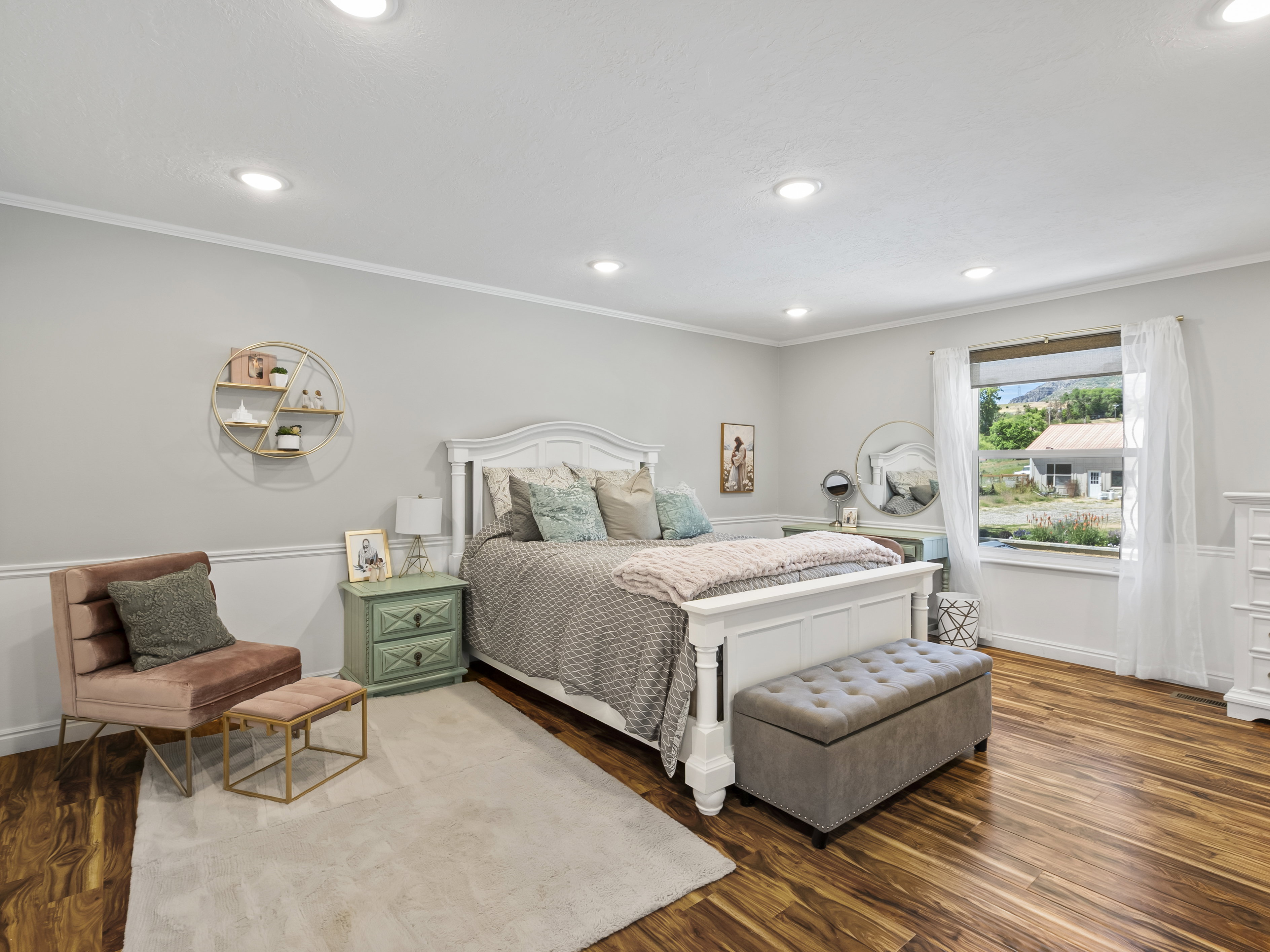 Spacious room featuring rich wood-finish flooring, recessed lighting, and a window with white trim