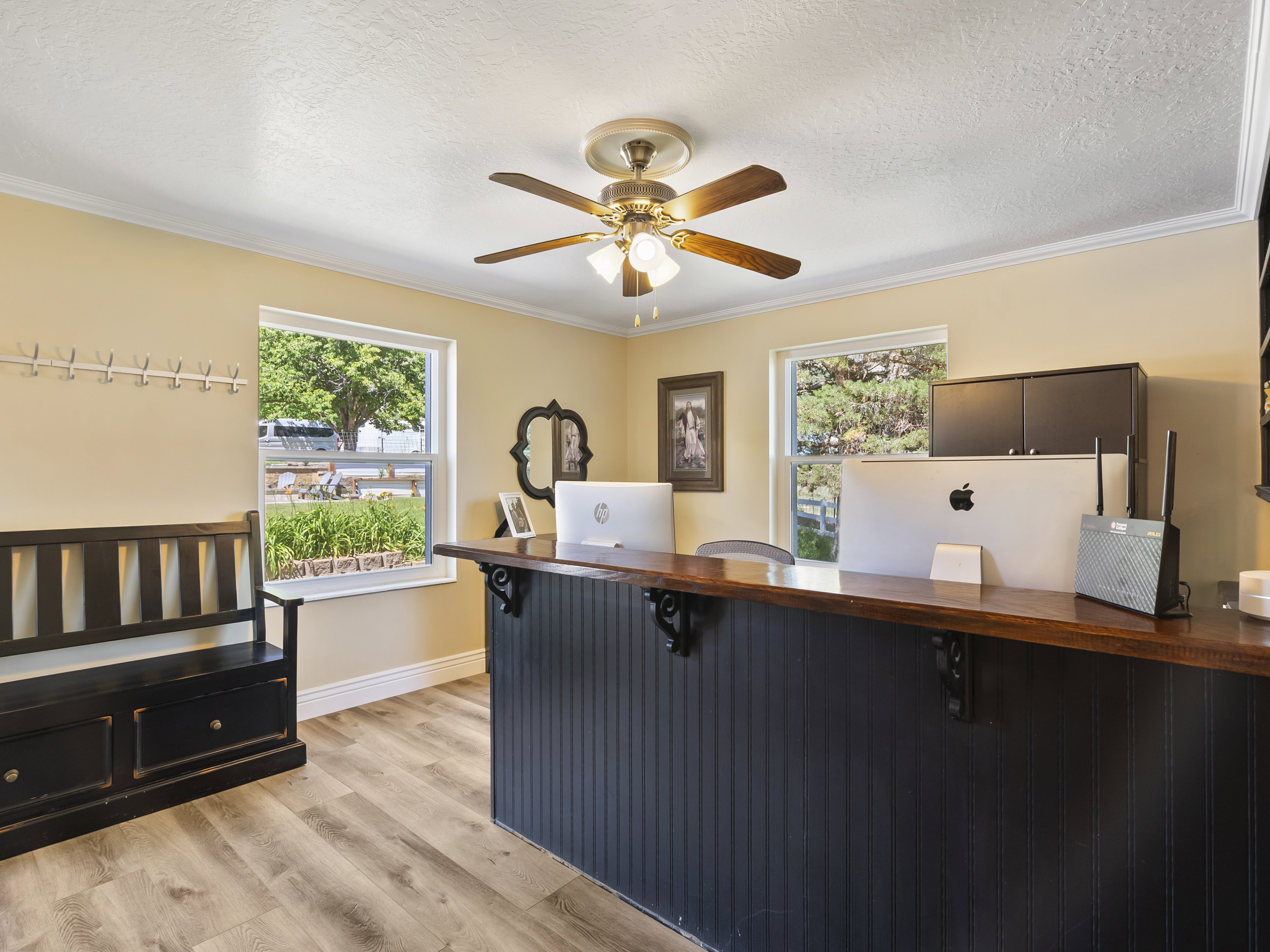 Spacious room featuring wood-finish flooring and multiple windows