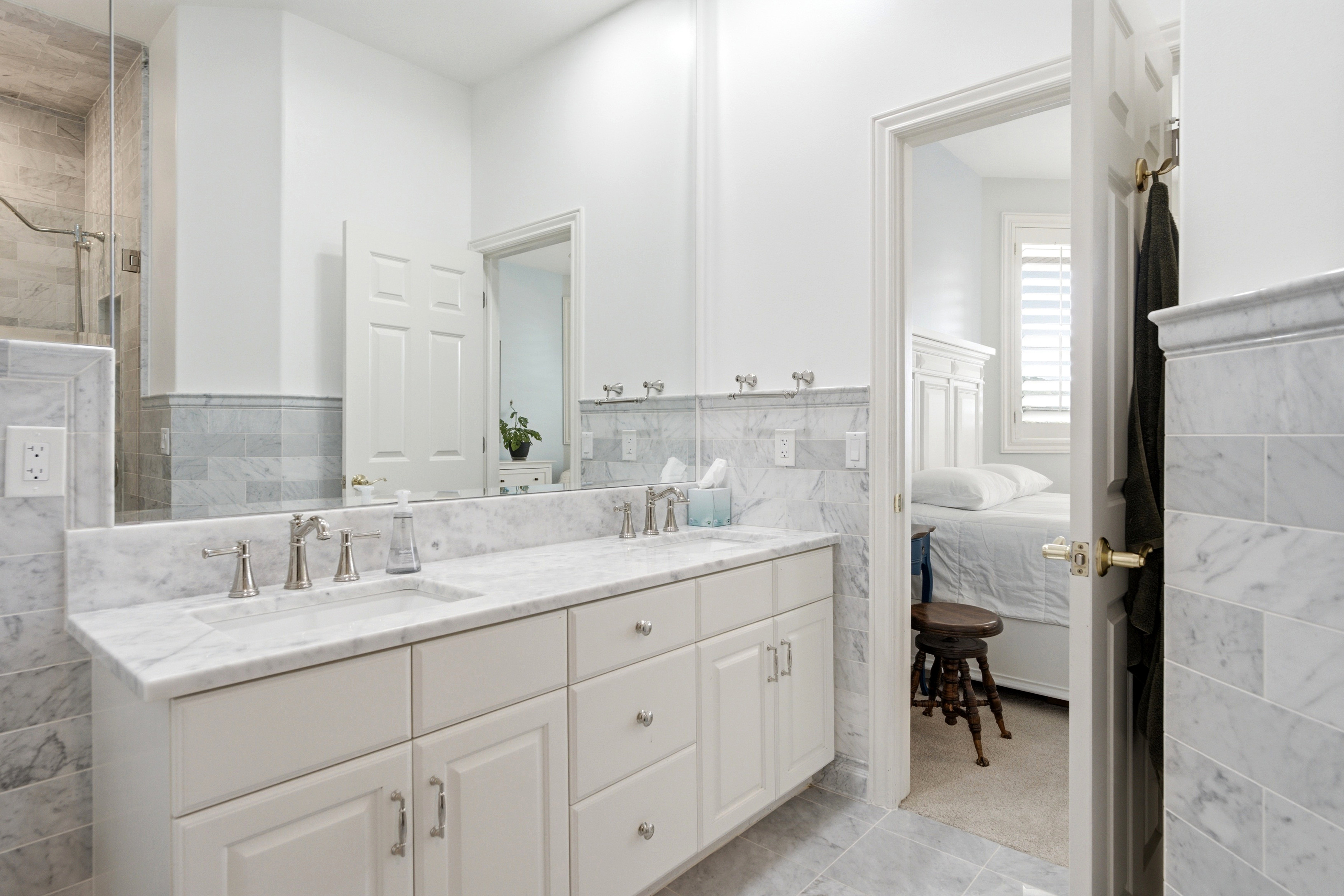 Jack and Jill Bathroom. Marble walls floors and countertops, double vanity with undermount sinks and walk-in shower w/ marble walls and brushed nickel fixtures