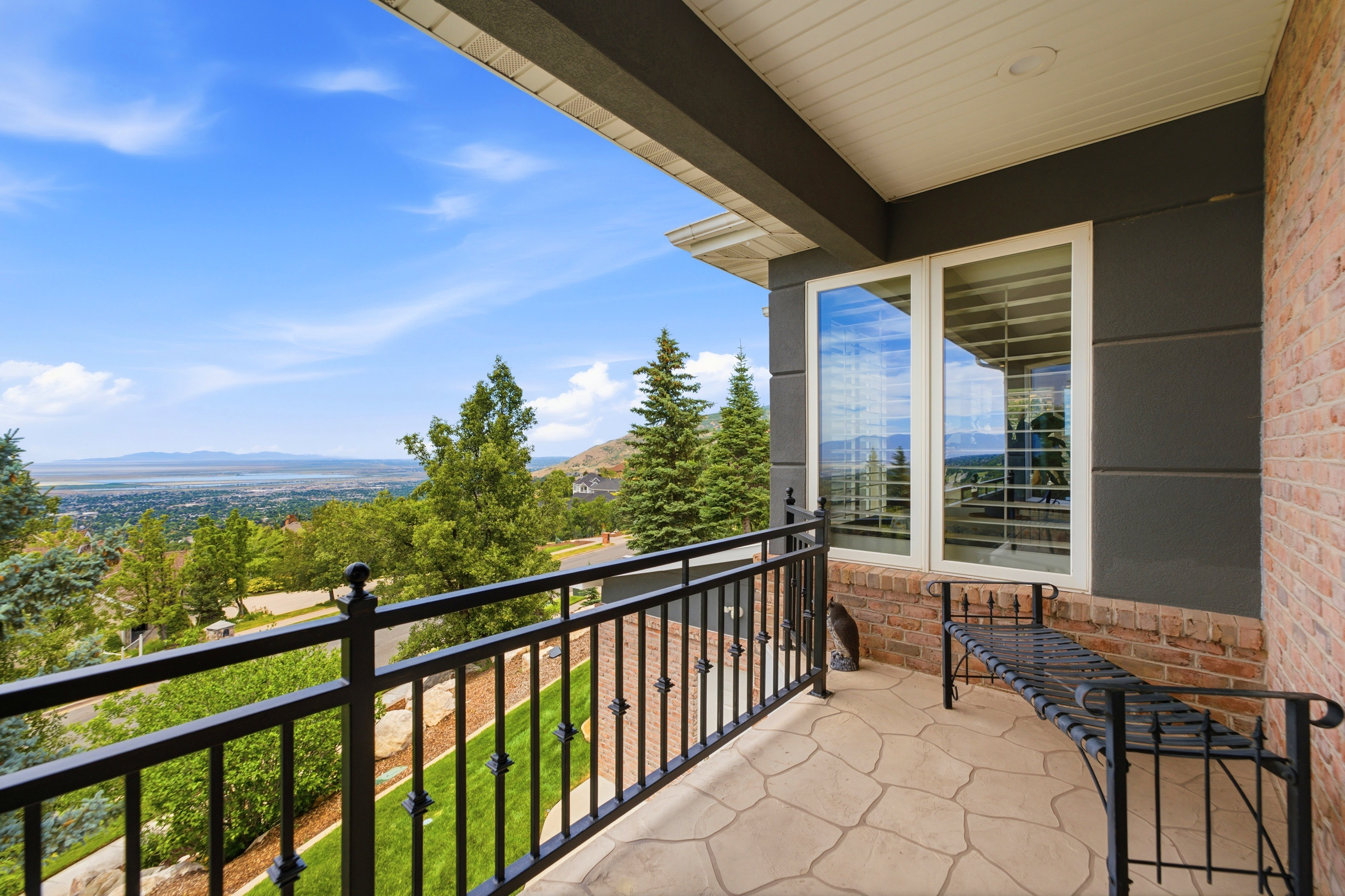 Front balcony with stamped concrete flooring and black wrought iron railings