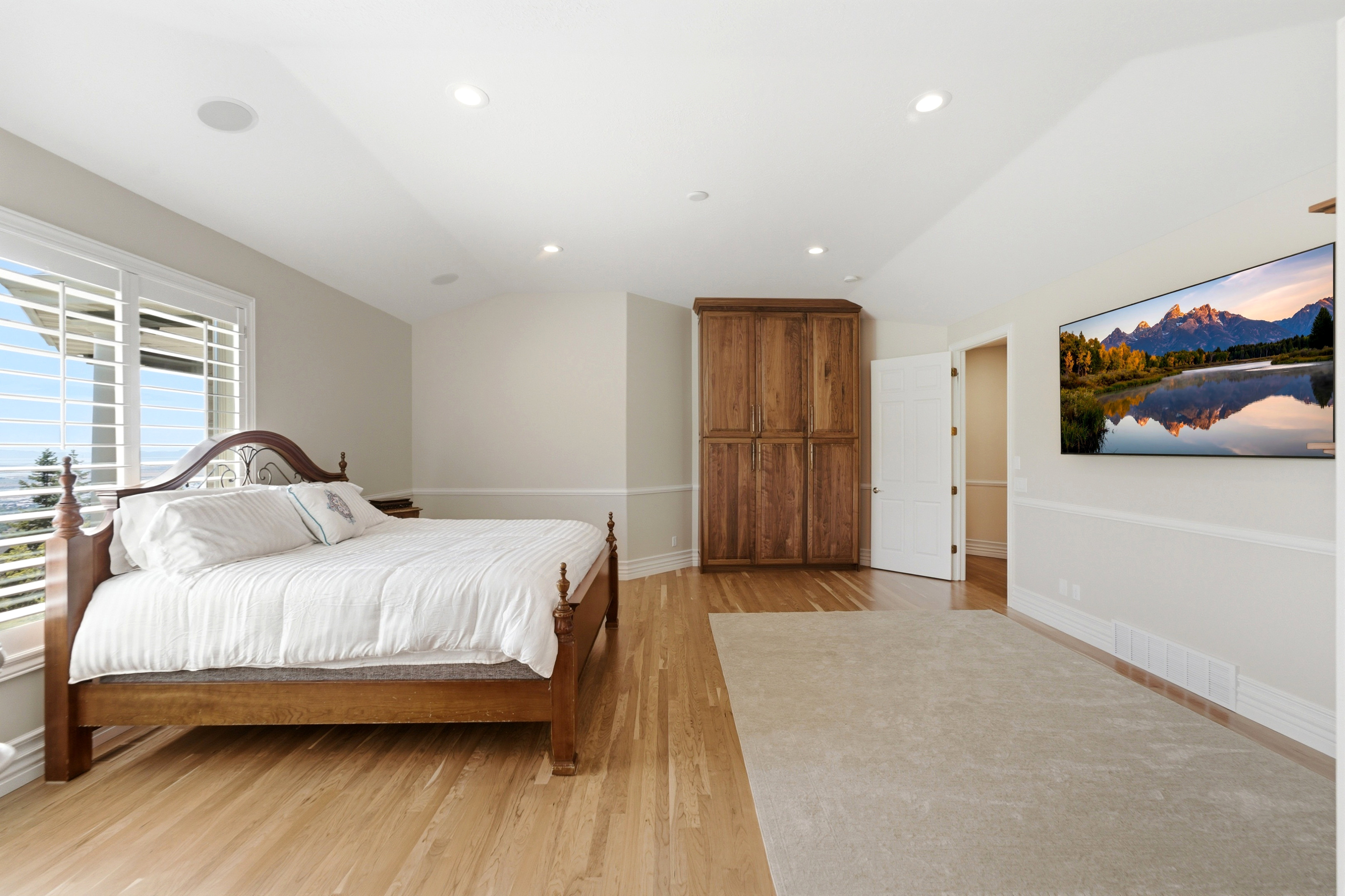 Light wood-finish flooring with a partial area rug and a built-in wood cabinet