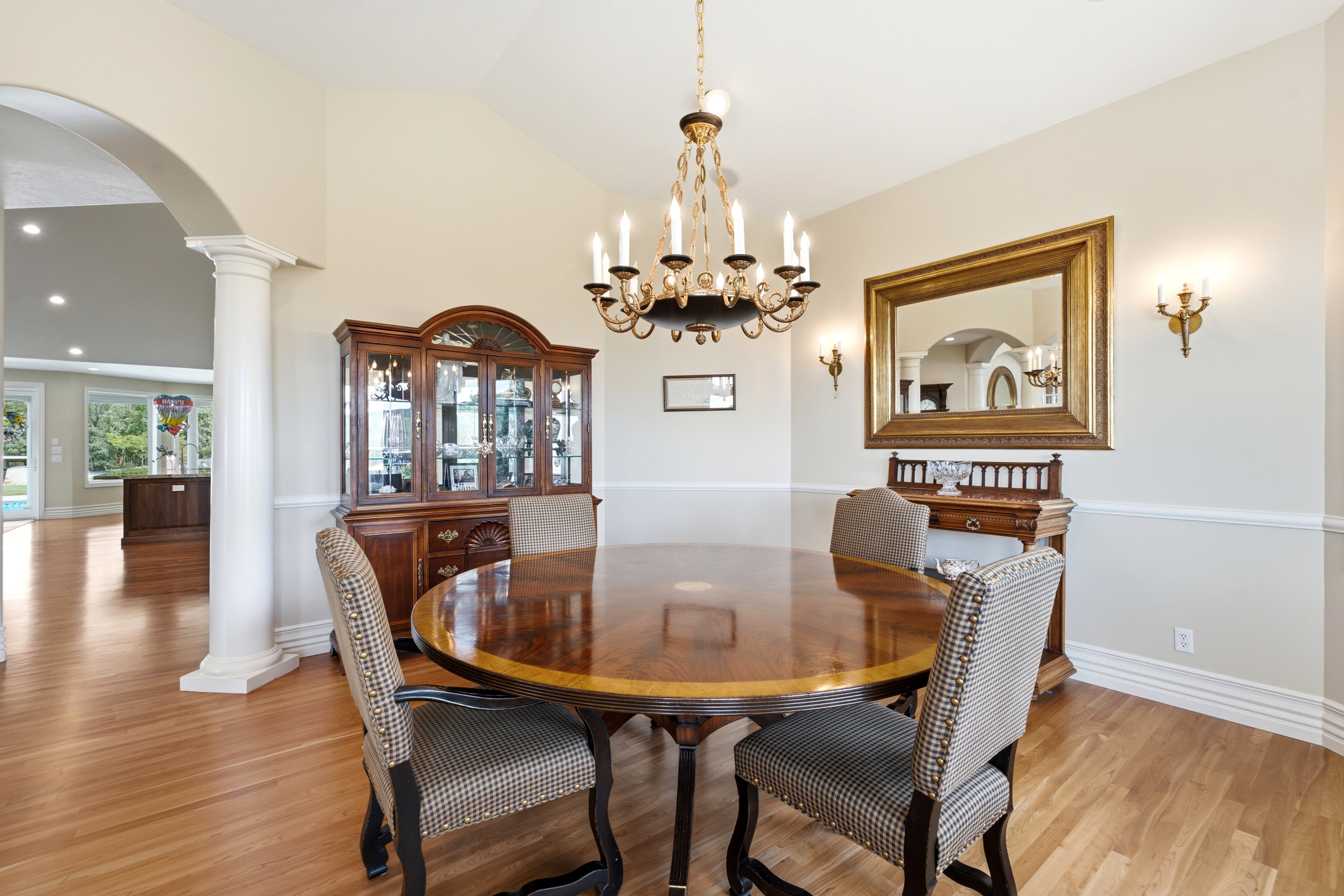 Formal dining space featuring wood-finish flooring and a decorative chandelier