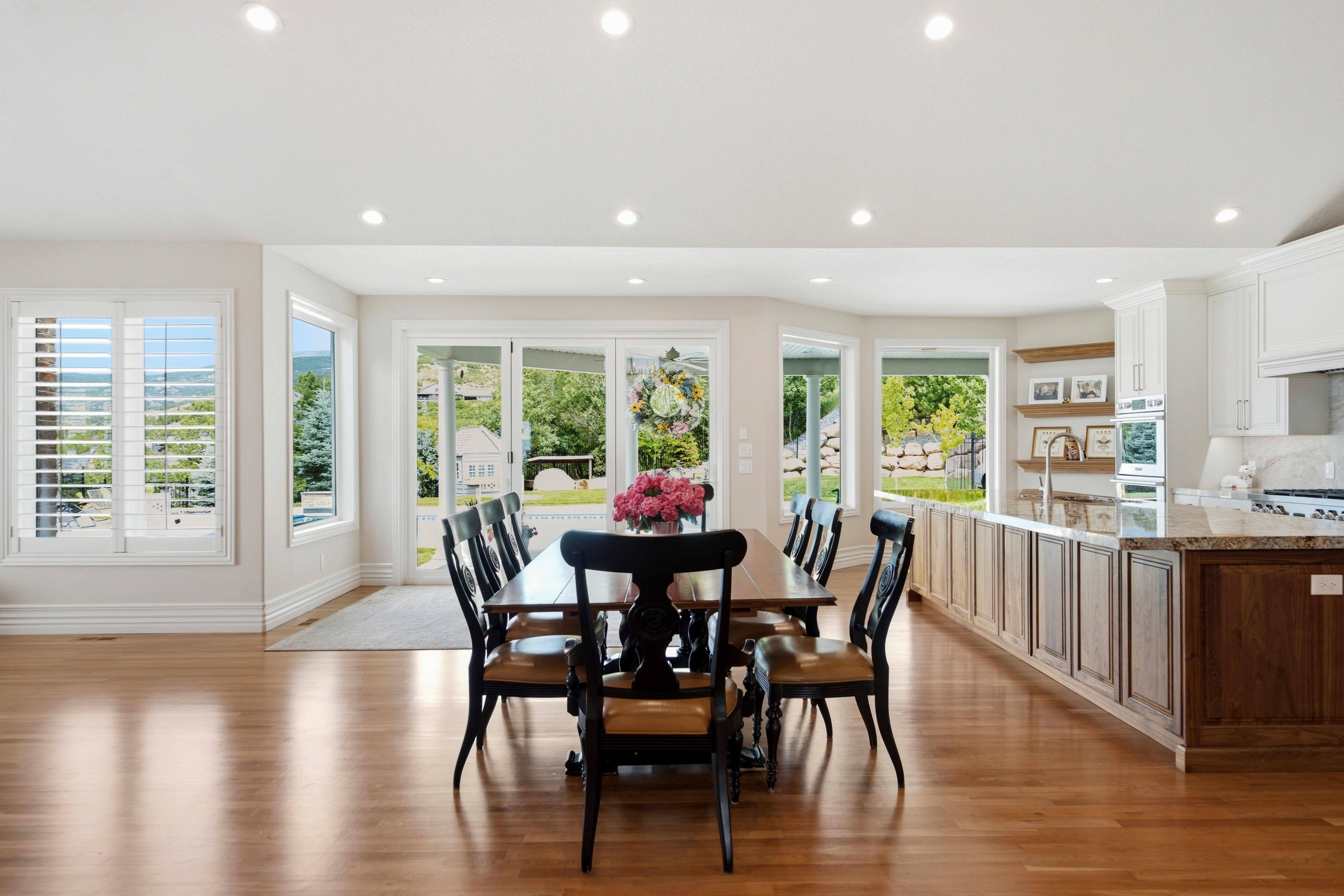 Open-concept living space featuring wood-finish flooring and recessed lighting