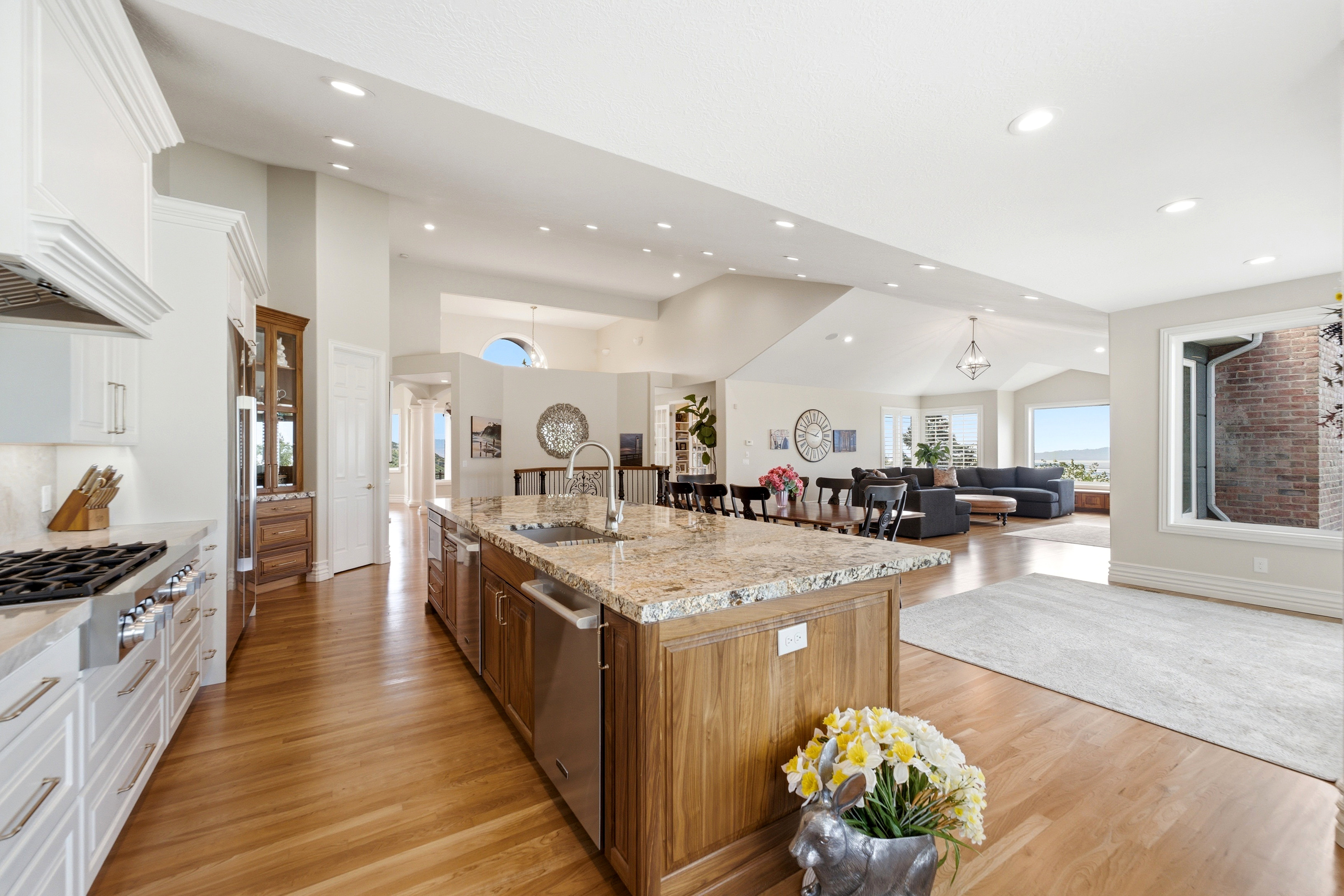 Expansive kitchen island featuring a dual basin sink and granite countertop