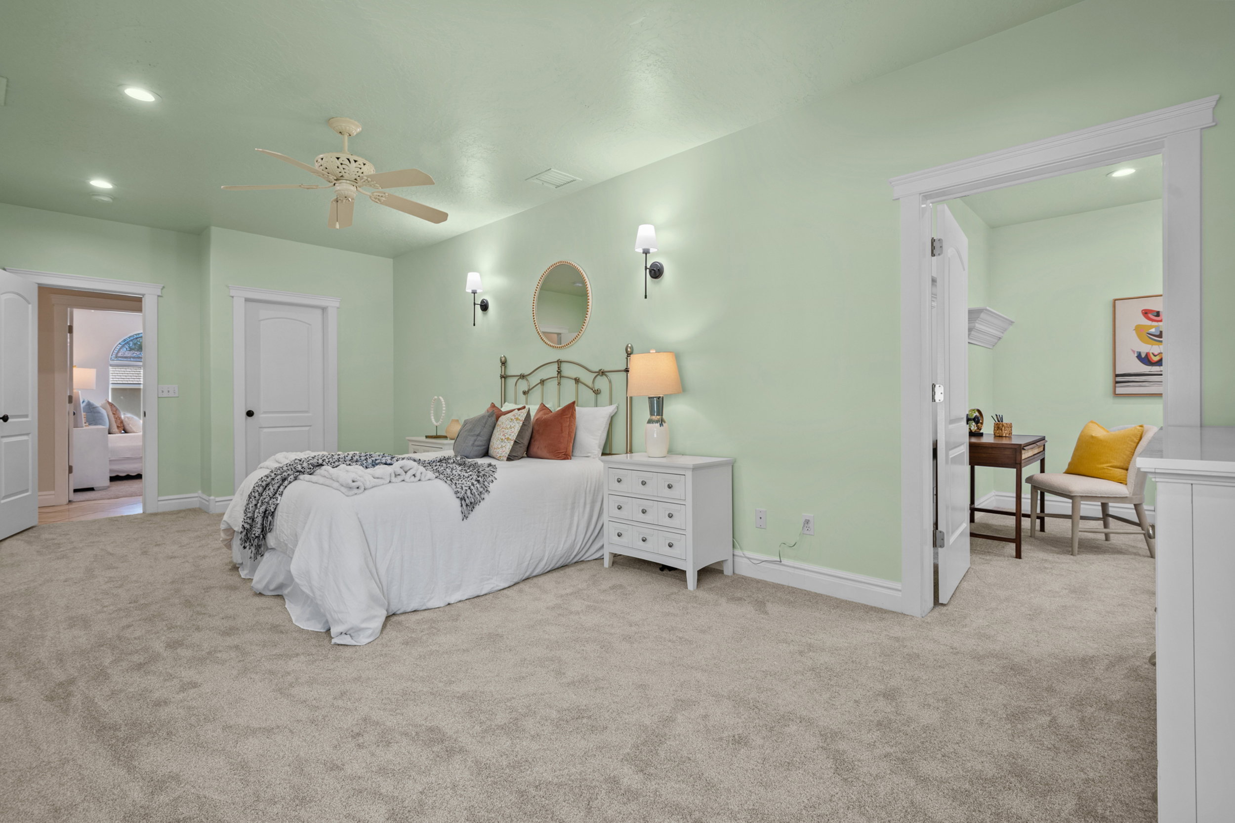 Carpeted bedroom featuring a ceiling fan with light fixture, recessed lighting, and wall sconces