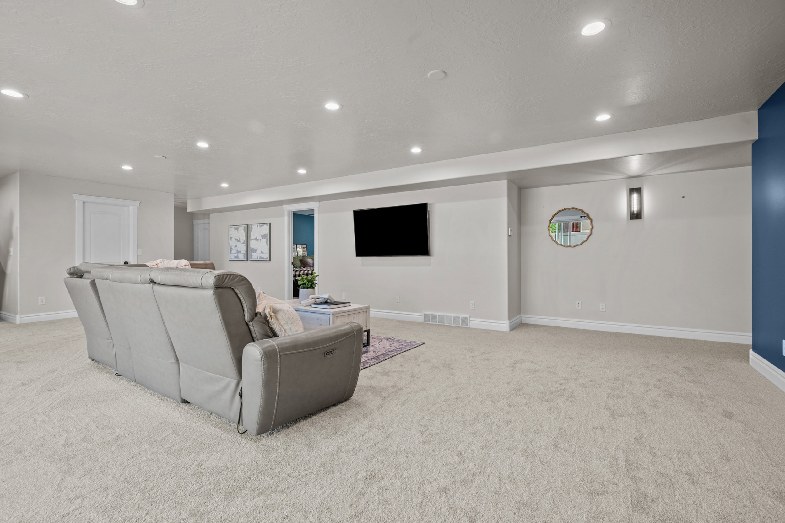 Spacious room featuring light-toned carpeting and recessed ceiling lighting