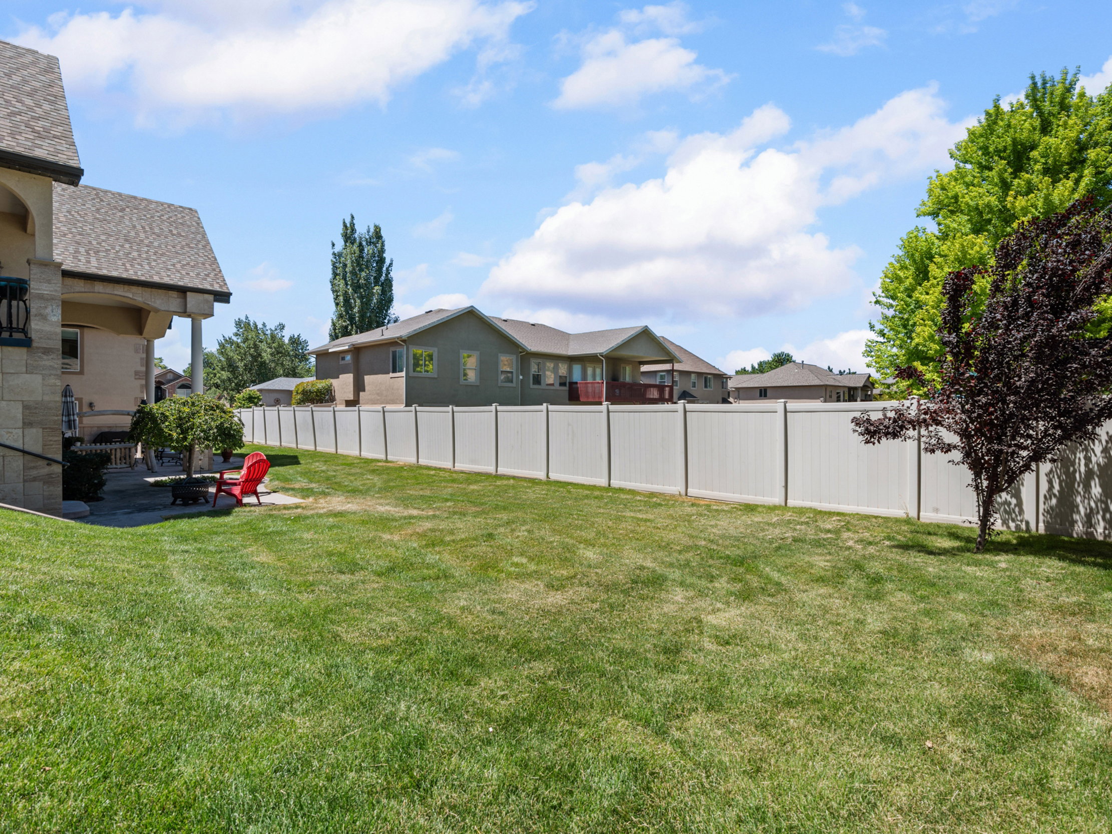 Spacious lawn area with a privacy fence