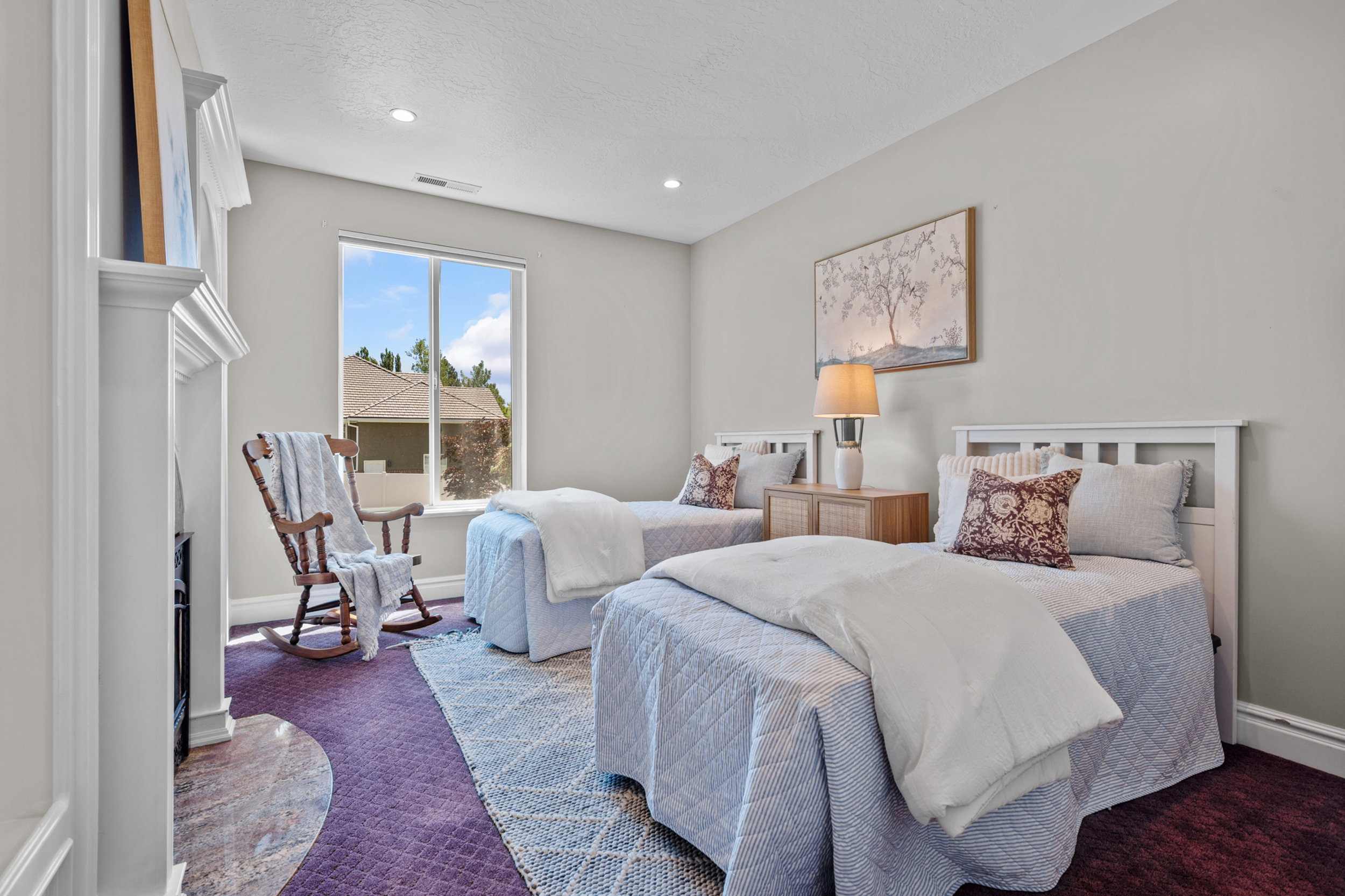 Perfect office, study or nursery/bedroom featuring a built-in fireplace with a stone surround and ornate white mantel, custom built-ins.