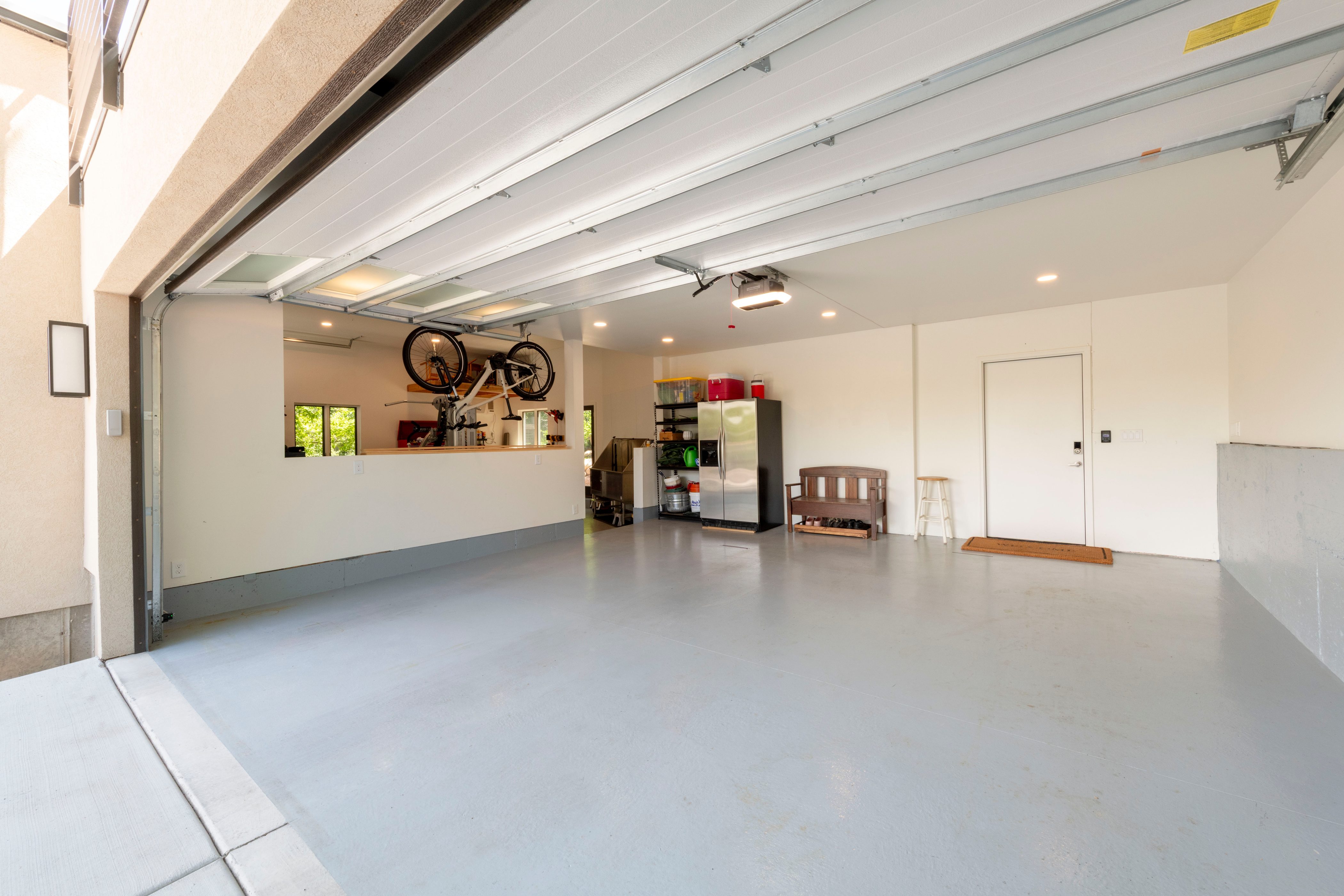 Spacious garage with a light gray epoxy floor and white walls