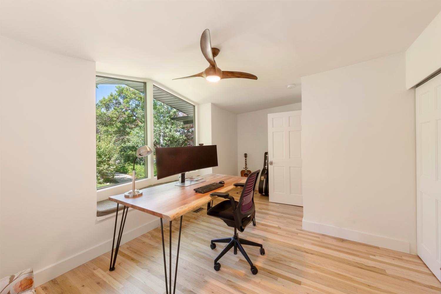 Room with light wood-finish flooring and white walls