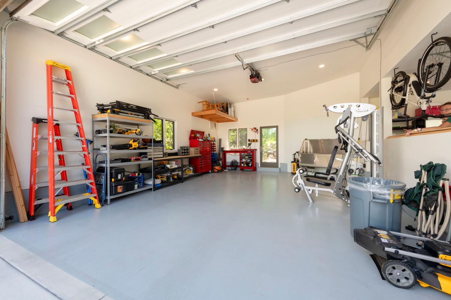 Spacious garage with light gray flooring and white walls