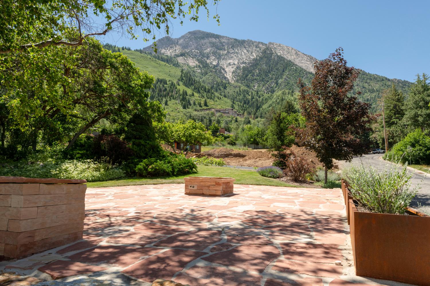 Expansive flagstone patio featuring a built-in fire pit