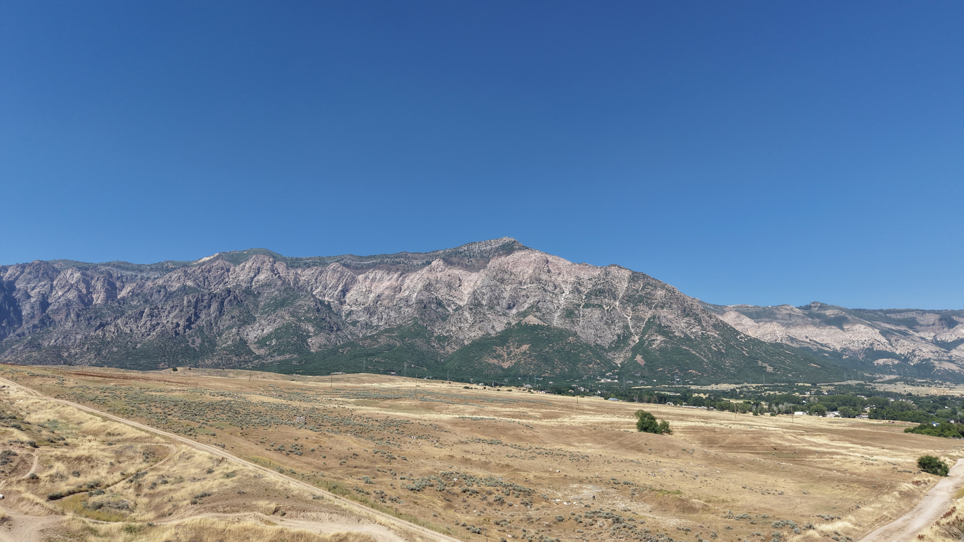Expansive mountain backdrop with a clear blue sky