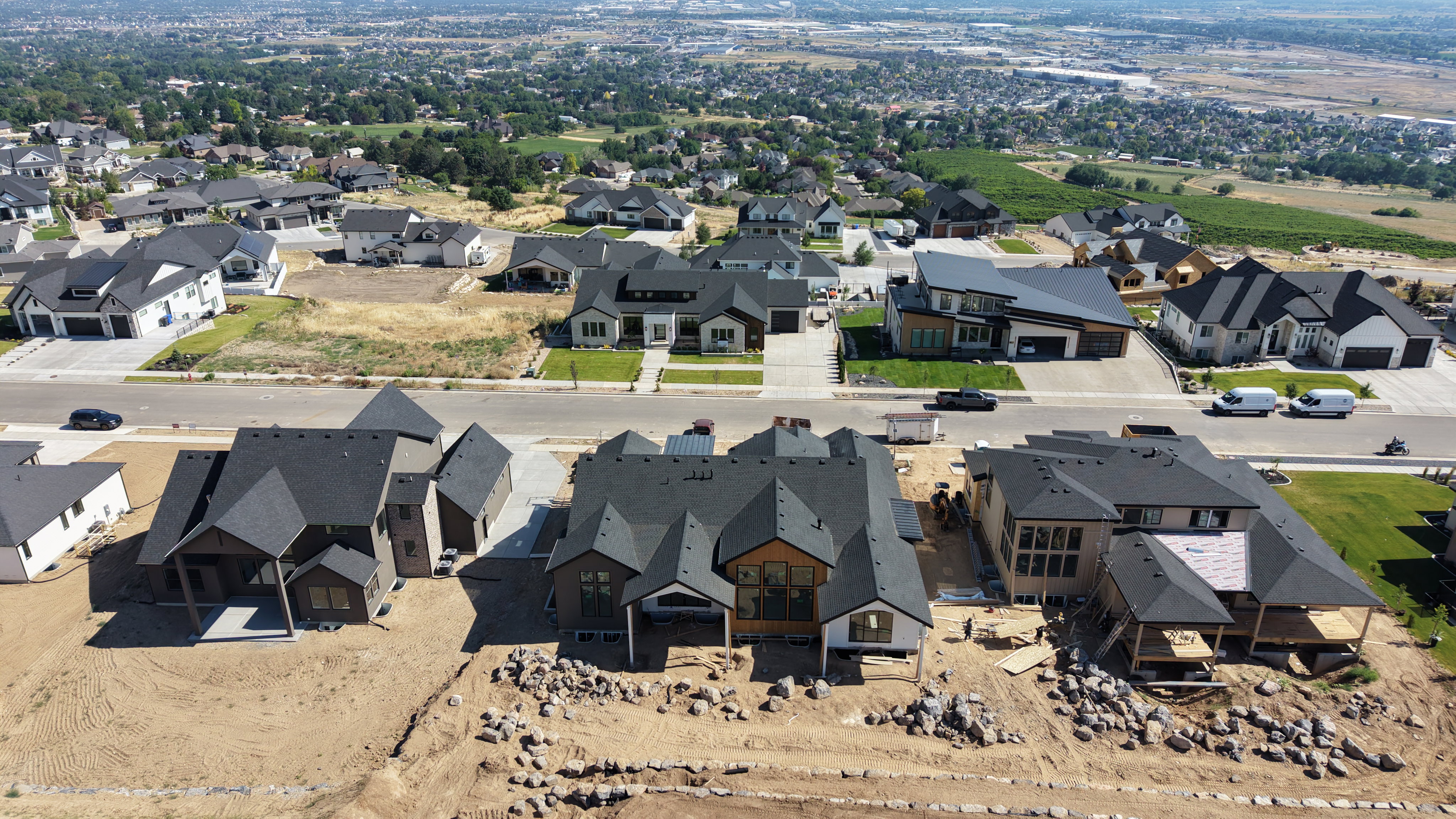 Aerial perspective showcasing a modern residential neighborhood with a variety of housing styles under construction