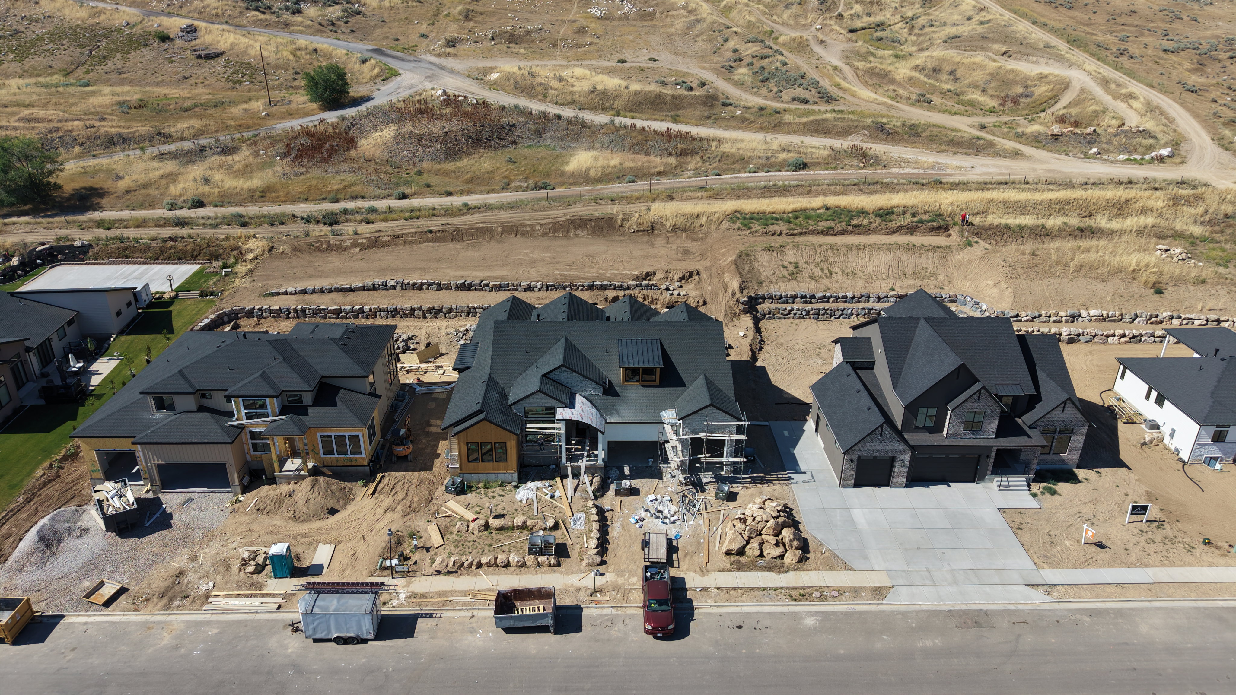 New construction property featuring a dark shingle roof, light-colored siding, and a concrete driveway