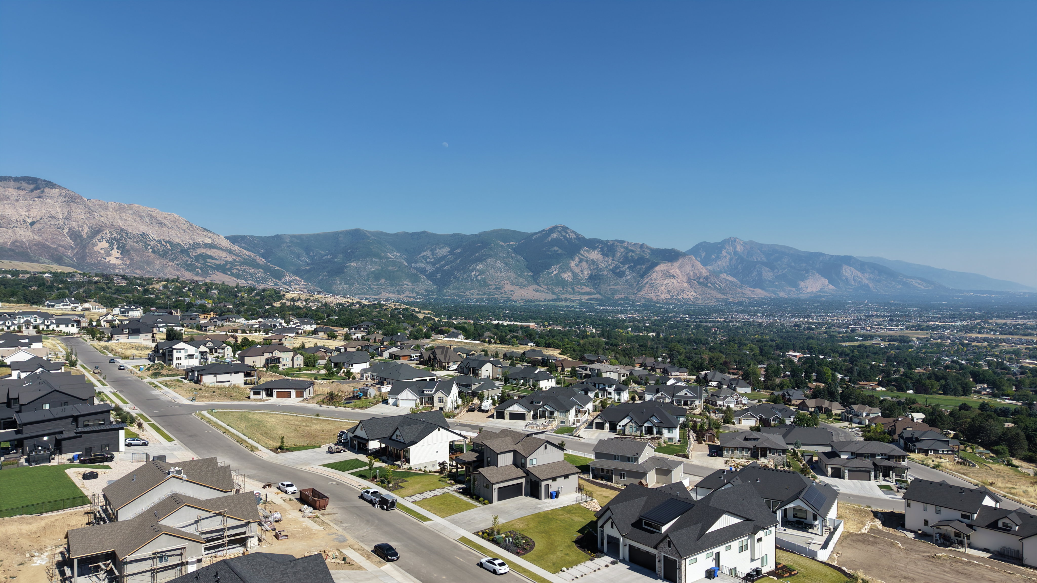 Expansive aerial perspective showcasing a residential development with a mountainous backdrop