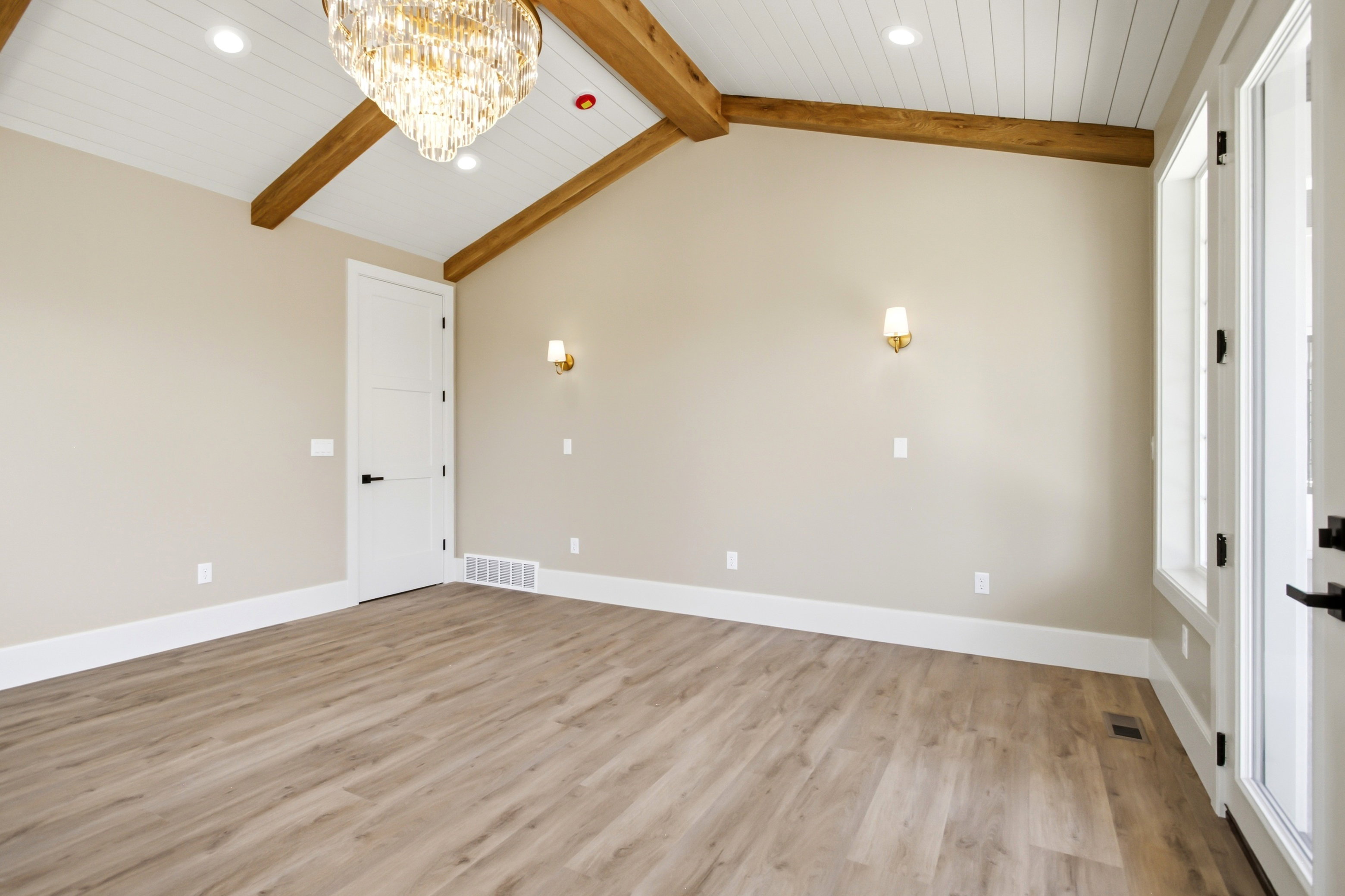 Primary Bedroom vaulted ceiling featuring exposed wood beams and shiplap paneling