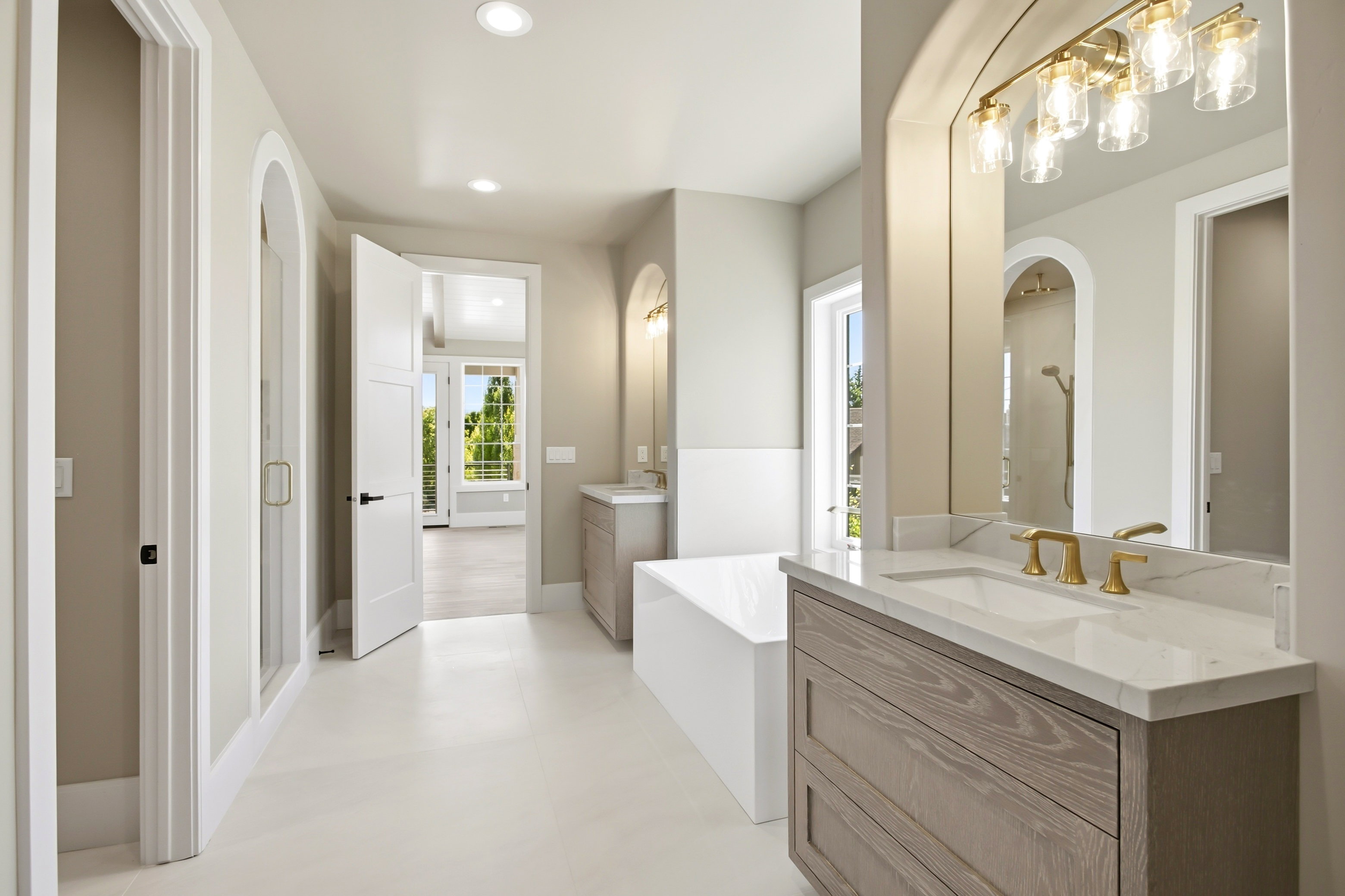 Dual vanity with light wood-finish cabinetry and white countertops