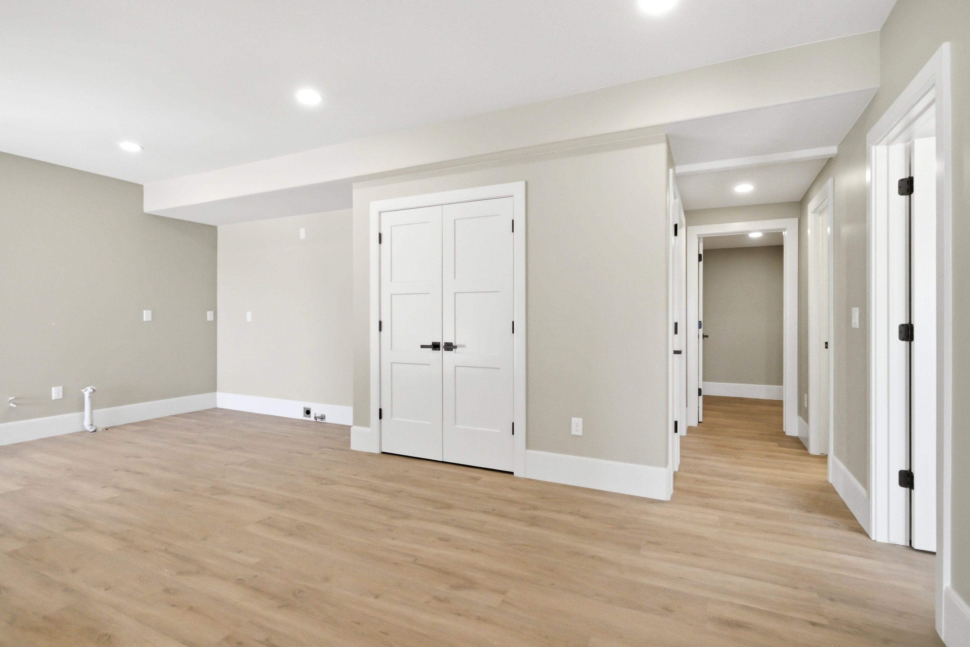 Lower level plumbed for full kitchen featuring, neutral gray walls, recessed lighting, and white baseboards