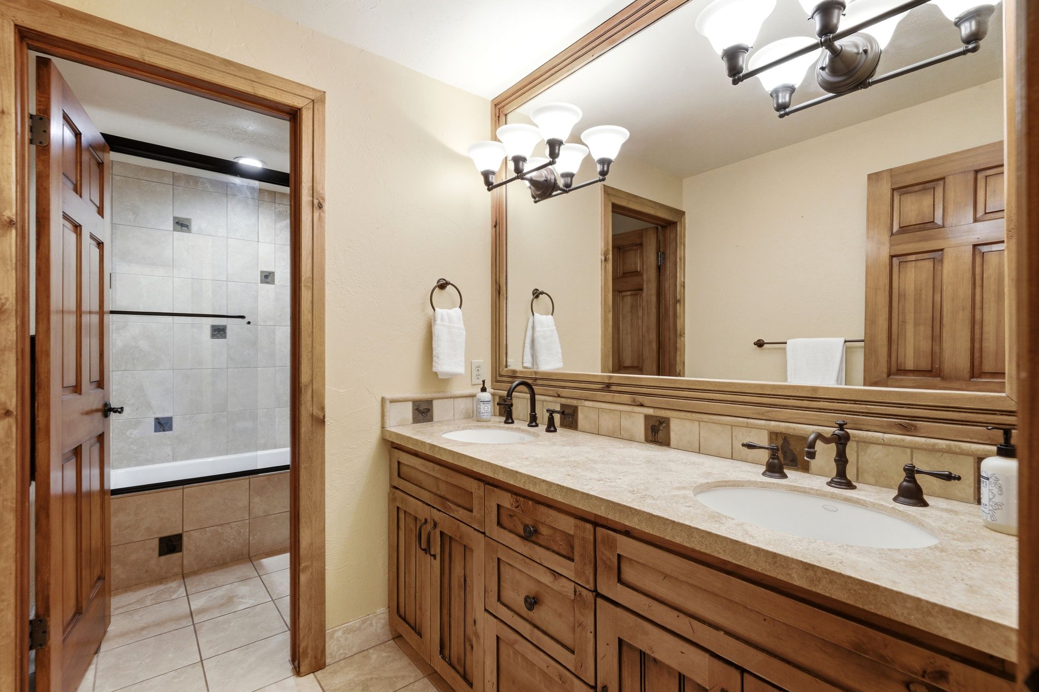 Dual vanity with undermount sinks and bronze-finish fixtures