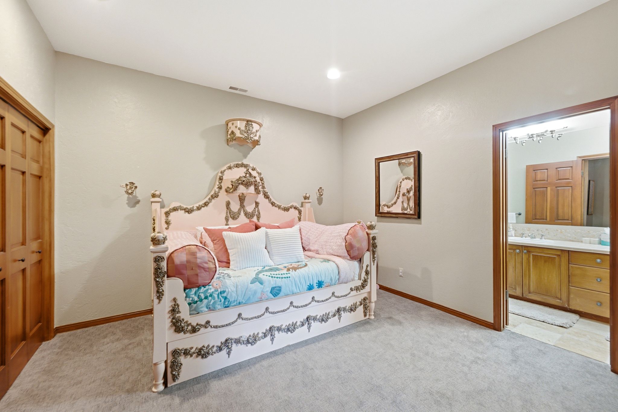 Room featuring light gray walls, gray carpeting, and natural wood baseboards