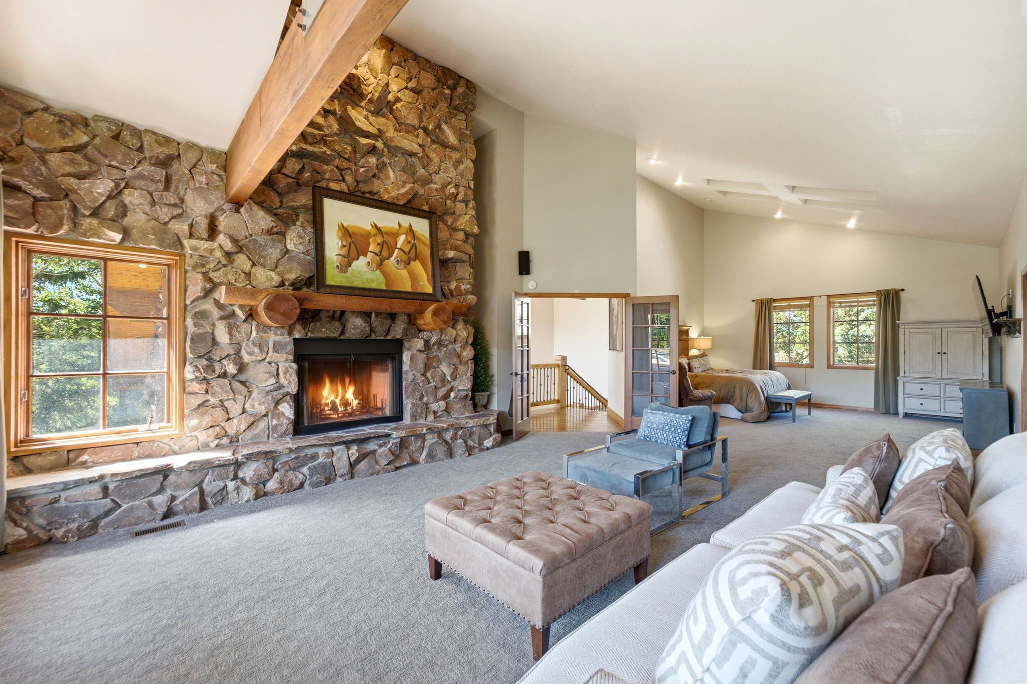 Stone fireplace with a log mantel and a hearth
