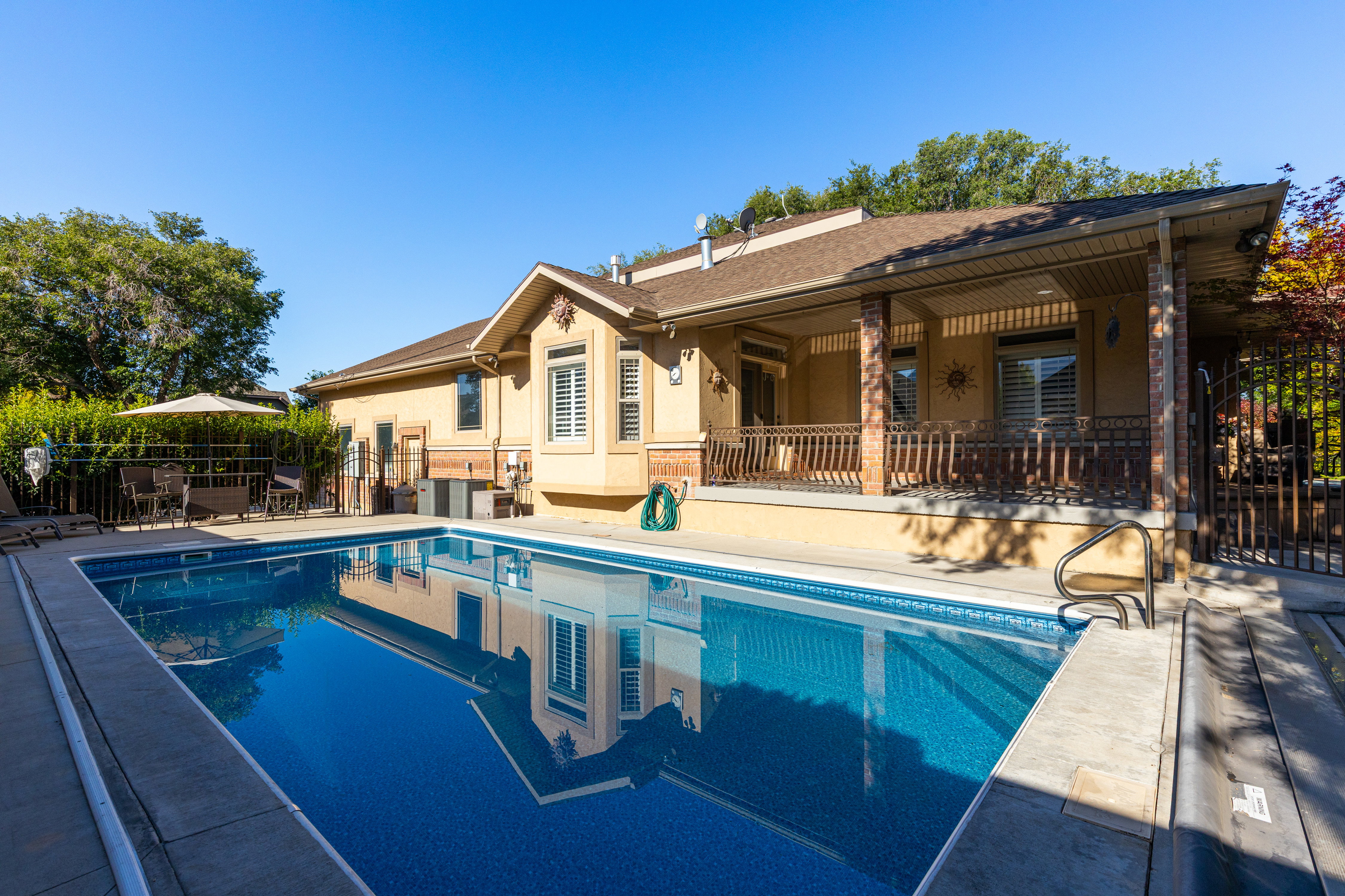 Outdoor swimming pool with integrated steps, surrounded by a concrete deck
