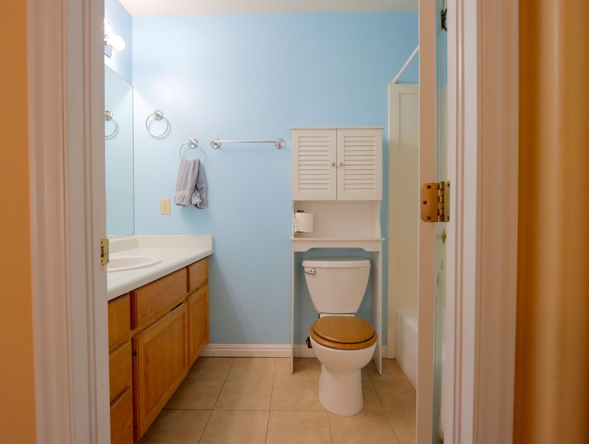 Bathroom featuring a single vanity with wood-finish cabinetry and a white countertop