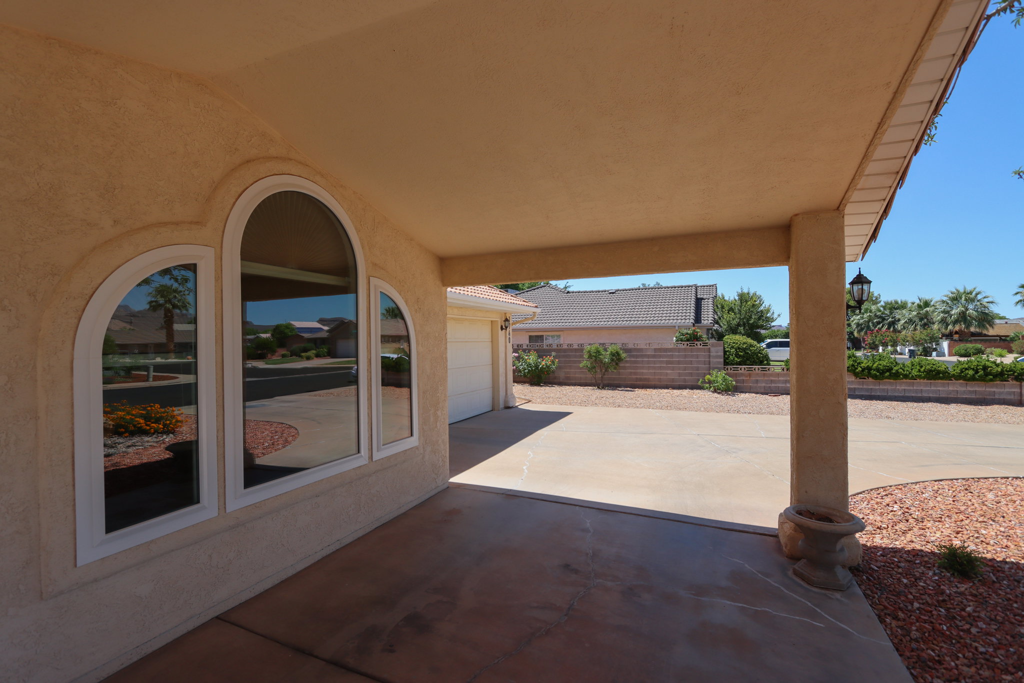 Stucco exterior featuring an arched window design