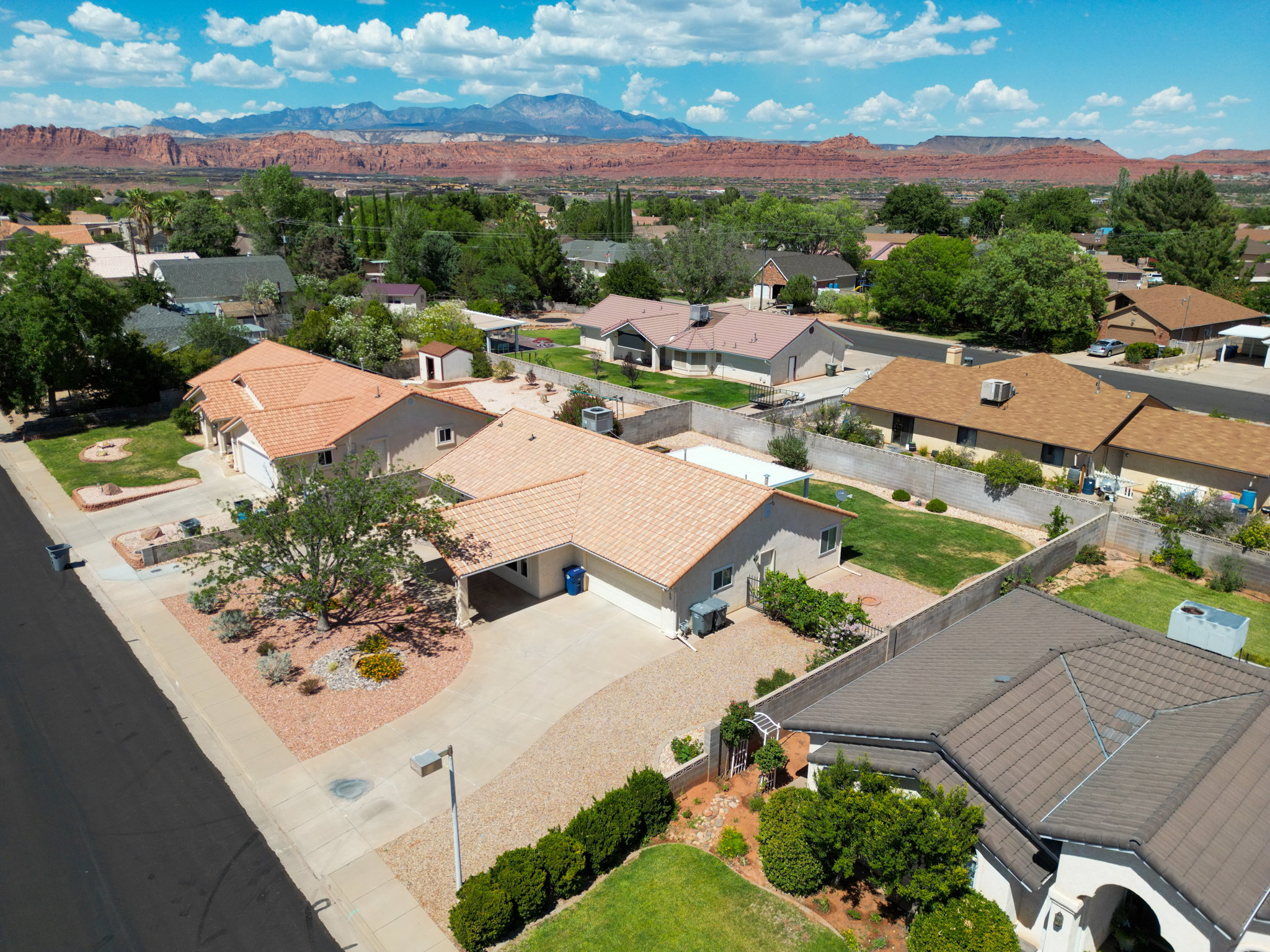 Single-story residence featuring a tile roof and a gravel driveway