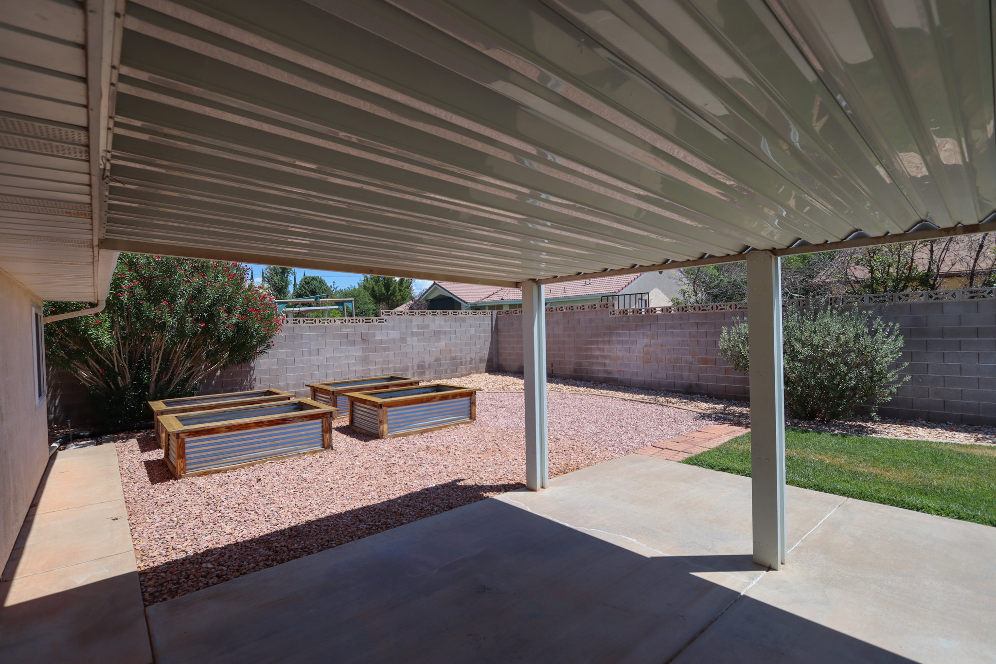 Covered patio featuring concrete flooring and support columns