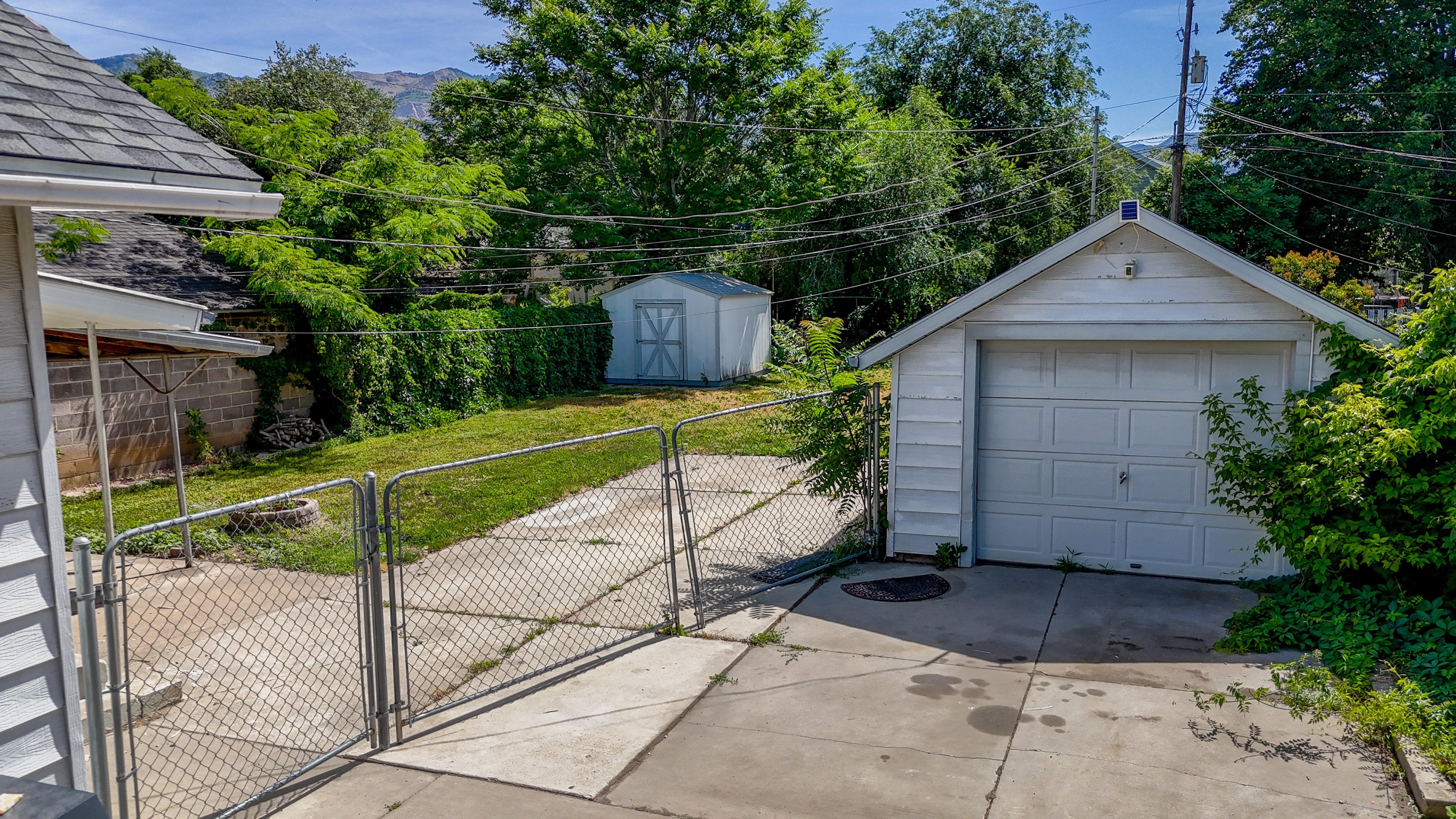 Detached garage featuring a paneled door and side access