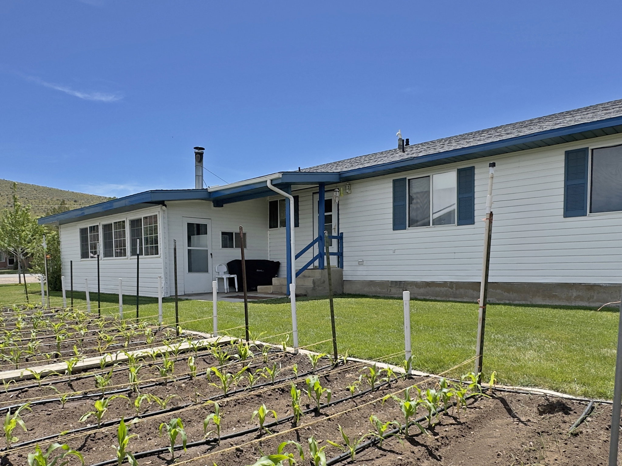 Expansive garden area featuring planted rows and an irrigation system