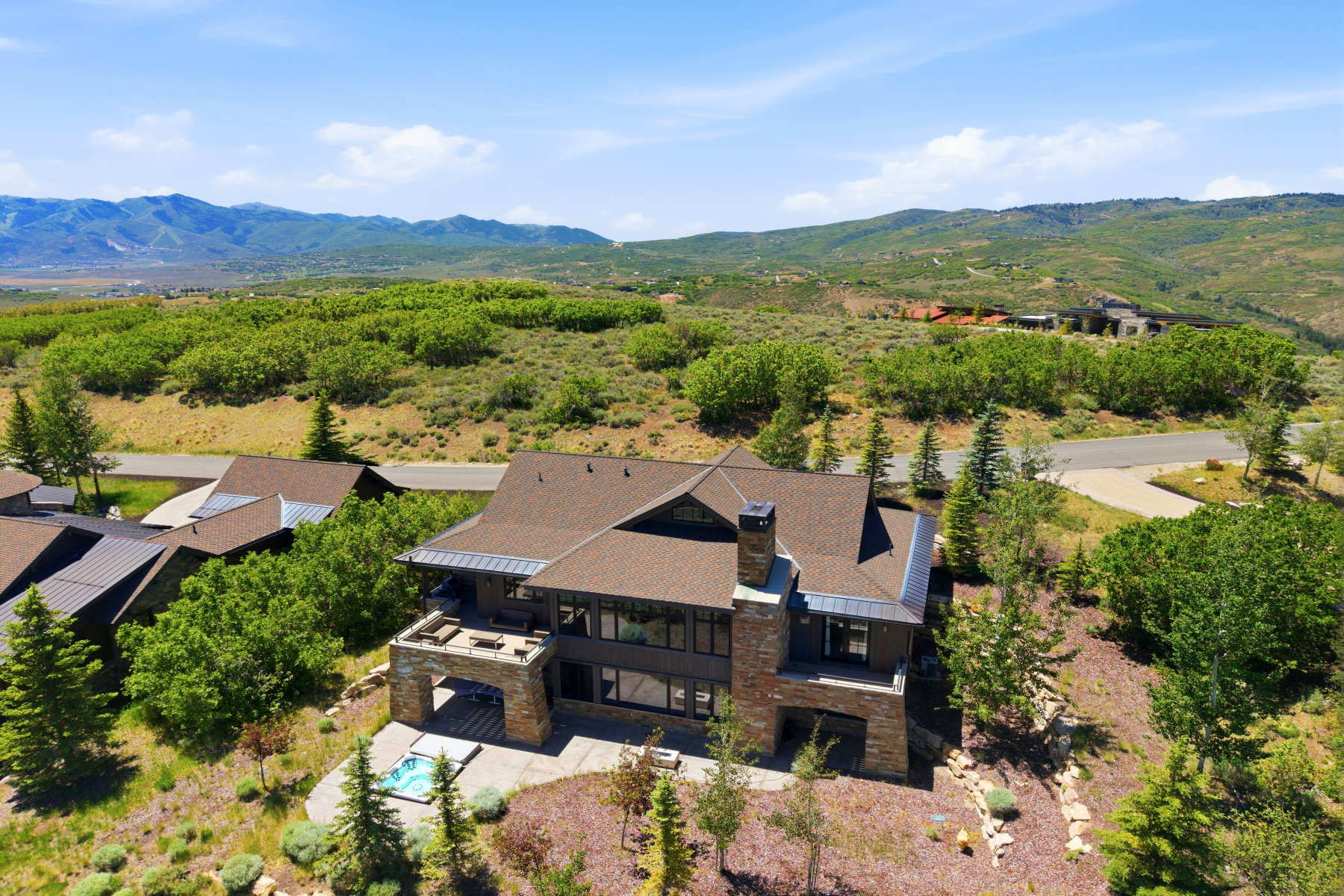 Contemporary residence featuring a multi-level design, stone accents, and a prominent chimney