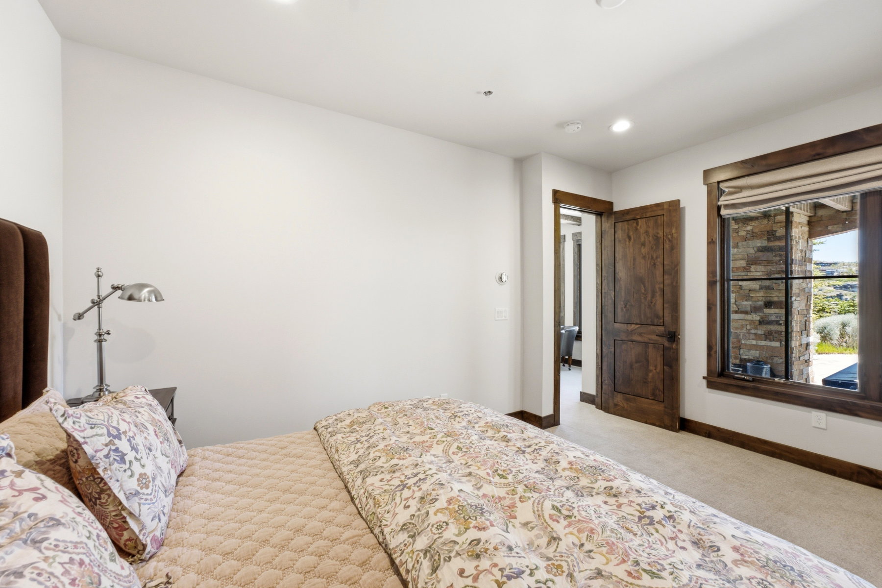 Interior room featuring a large window with stone detailing and dark wood trim